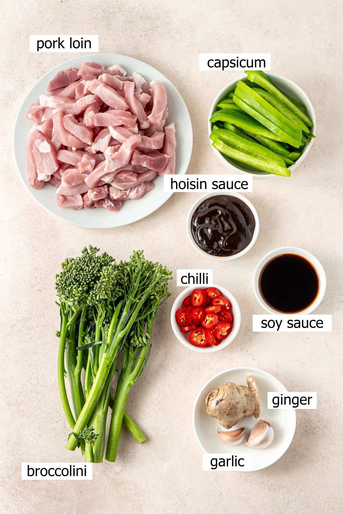 All ingredients needed for hoisin pork stir fry laid out in small bowls.