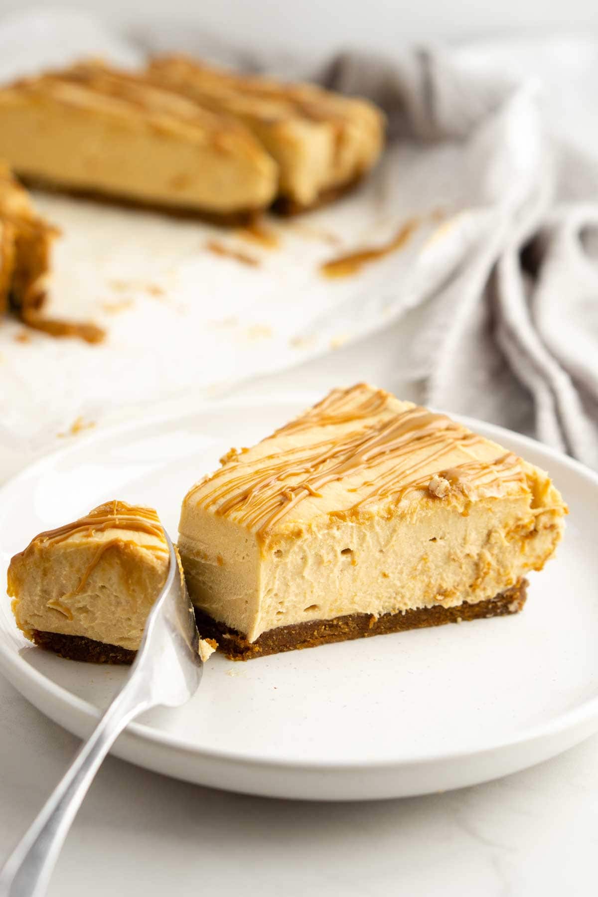 Slice of biscoff cheesecake with bite taken