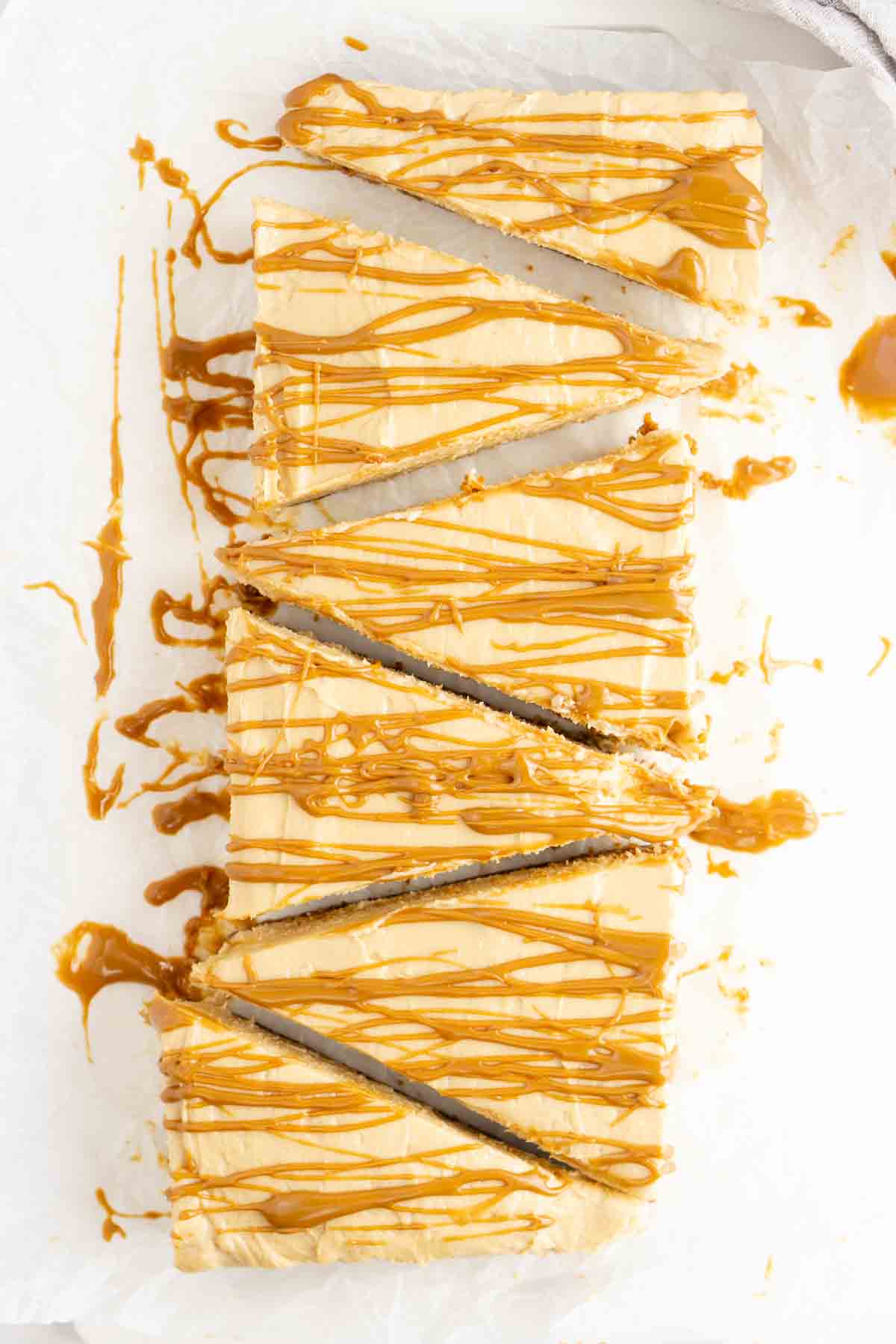 Slices of biscoff cheesecake with biscoff drizzle