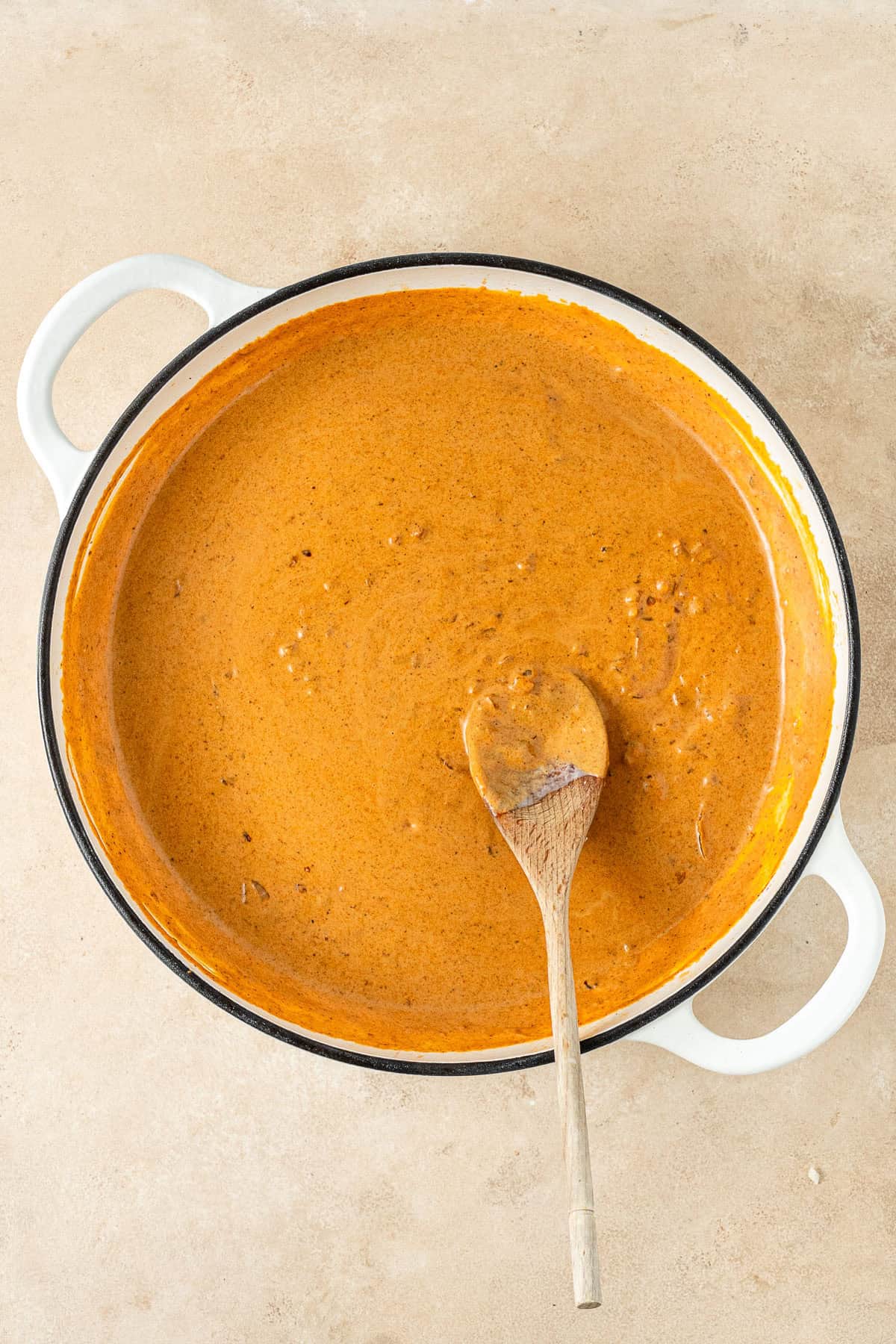Making the sauce by mixing through the coconut milk.