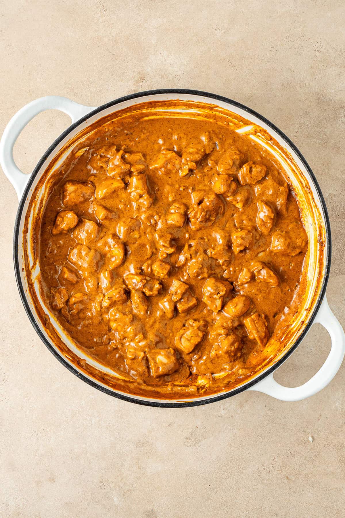 The chicken returned to the pan with the sauce.