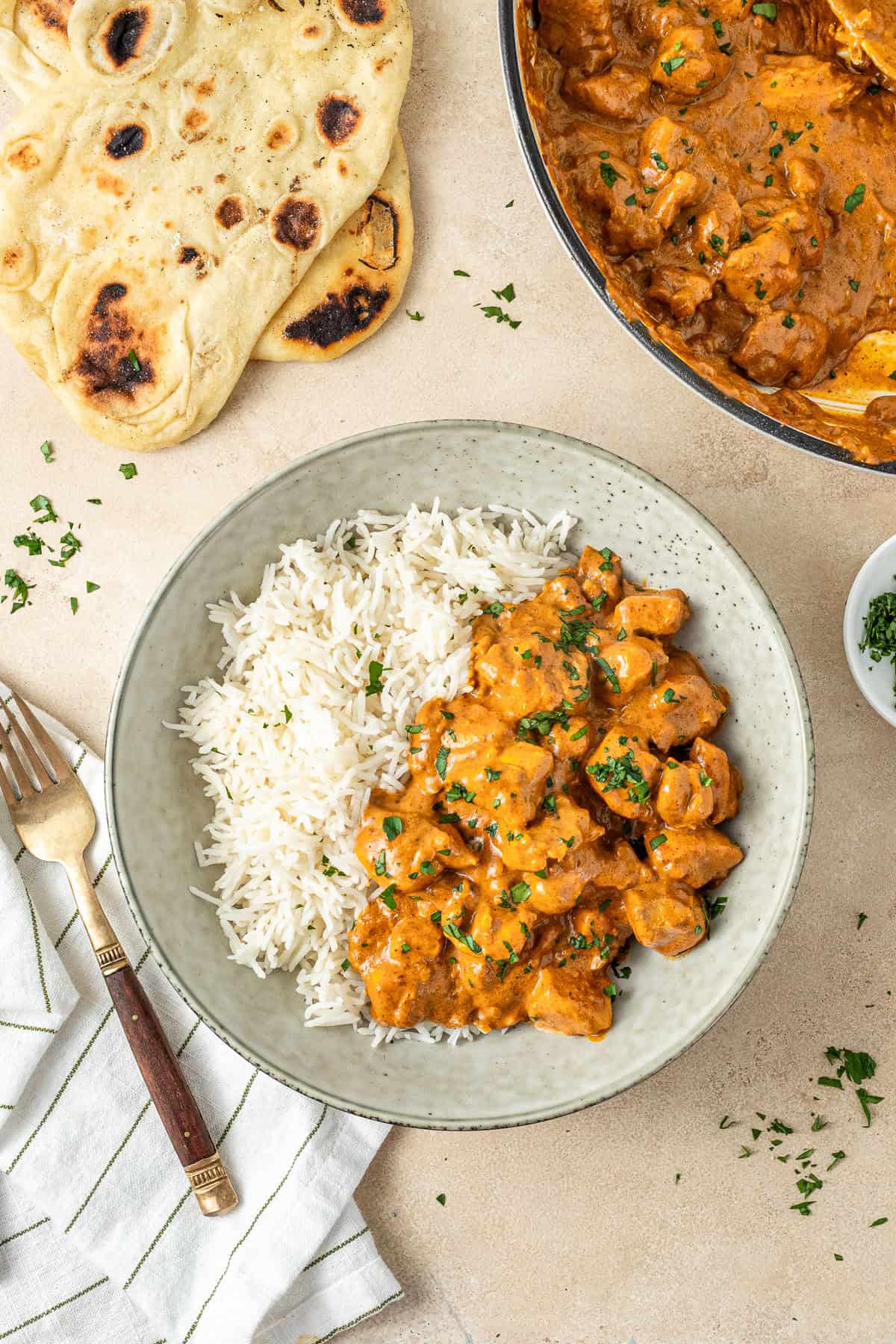 Dairy free butter chicken served with white rice and naan bread.