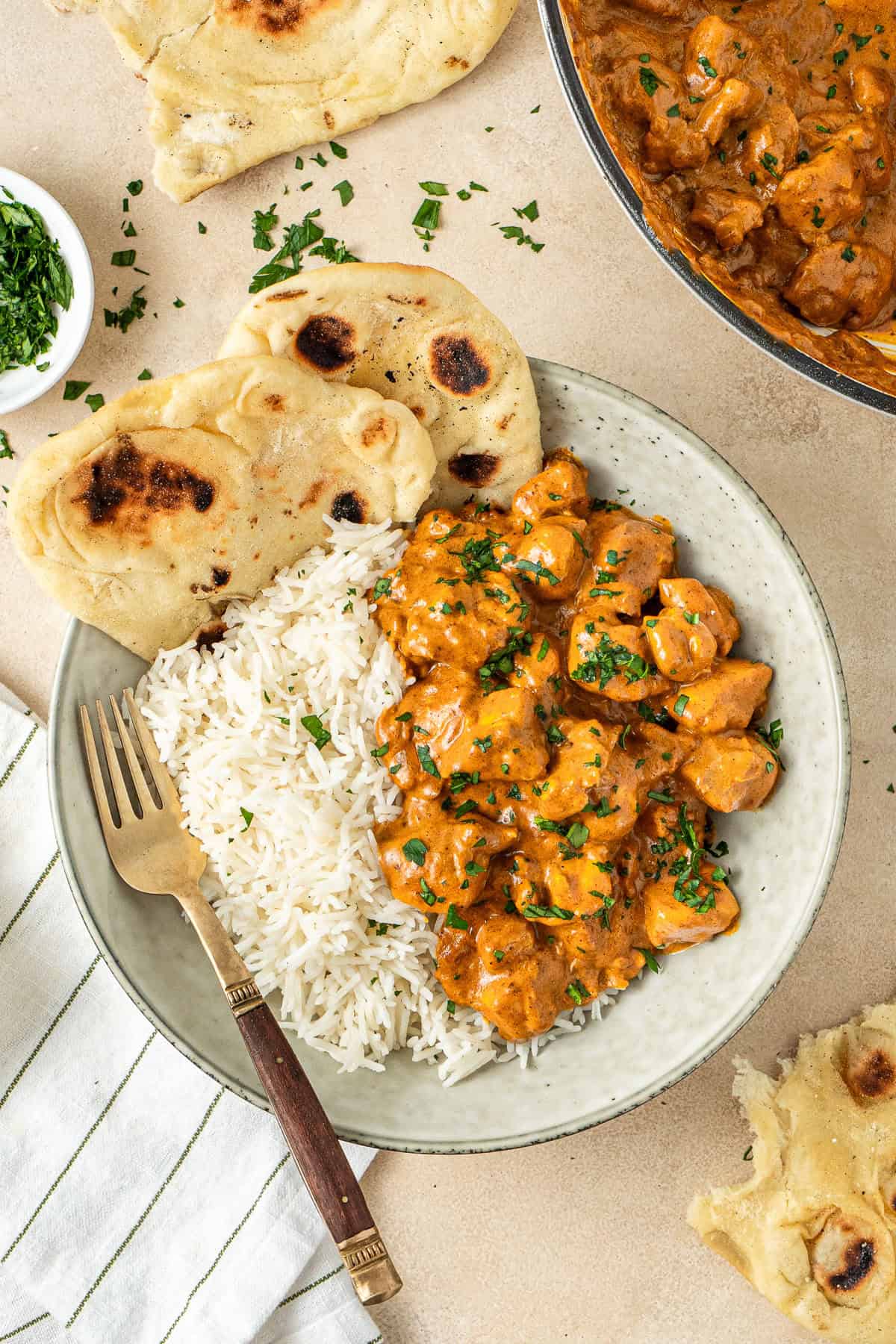 Dairy free butter chicken served with white rice and naan bread.