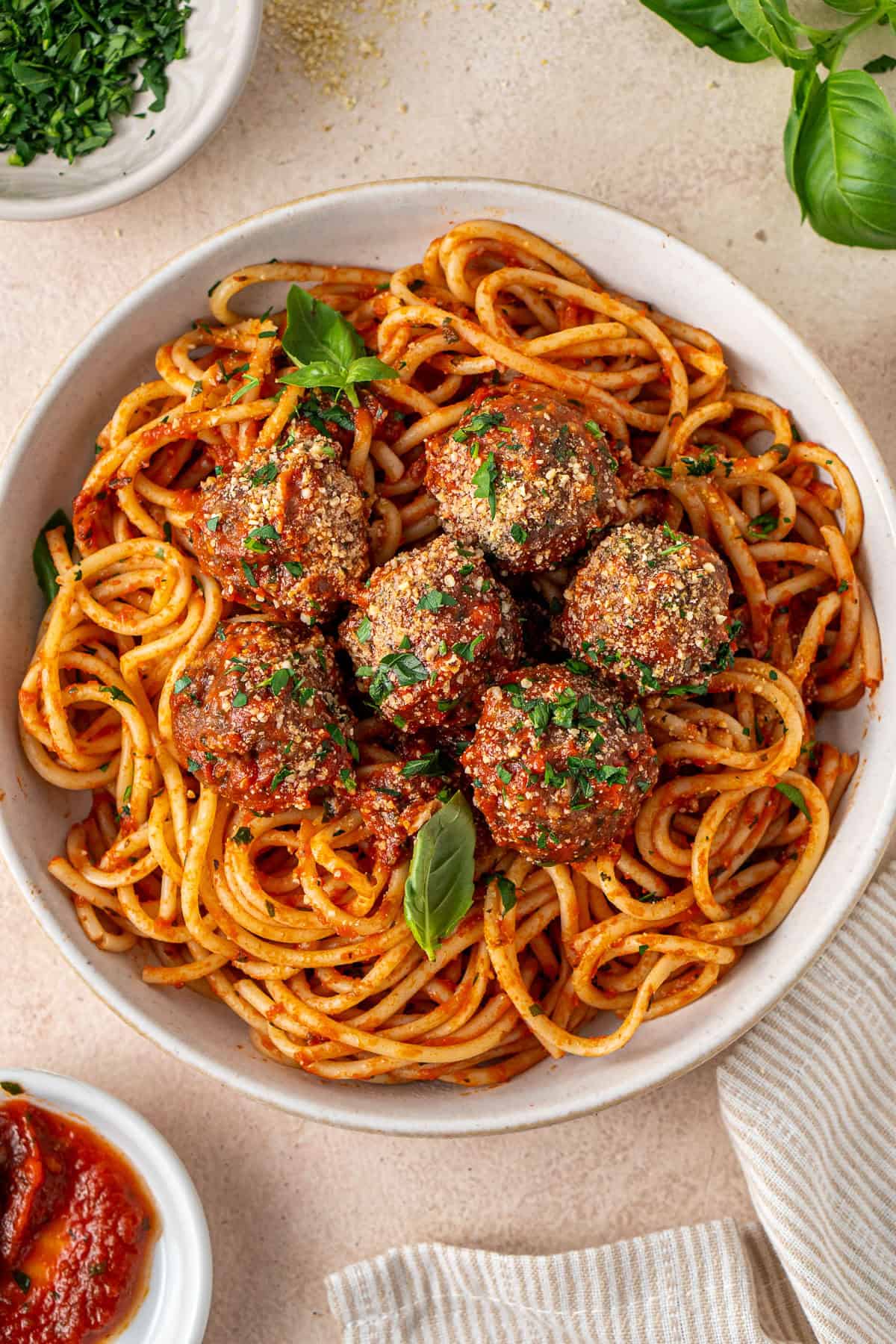 Baked beef meatballs served in marinara sauce over spaghetti. 