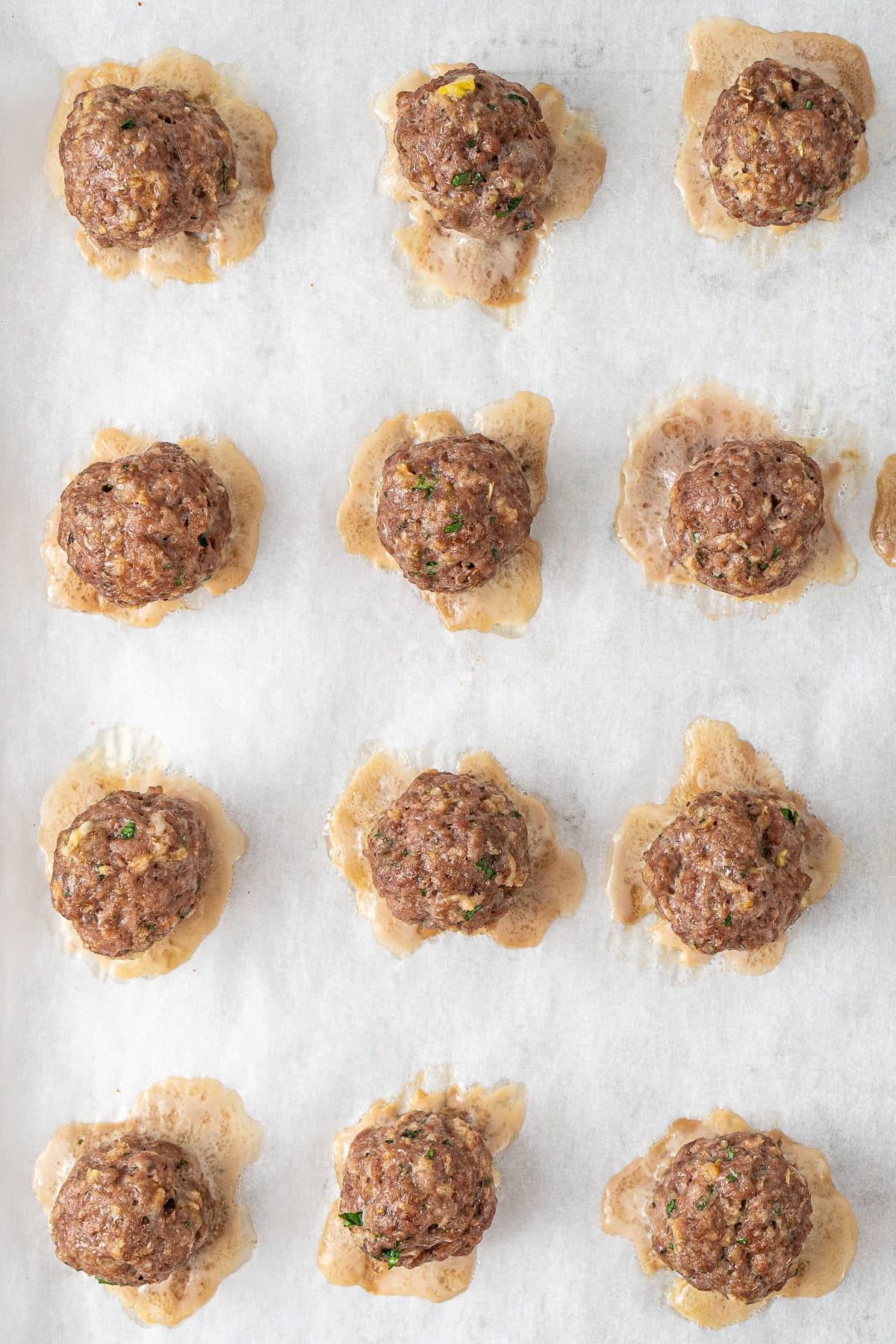 The baked meatballs on a baking tray.