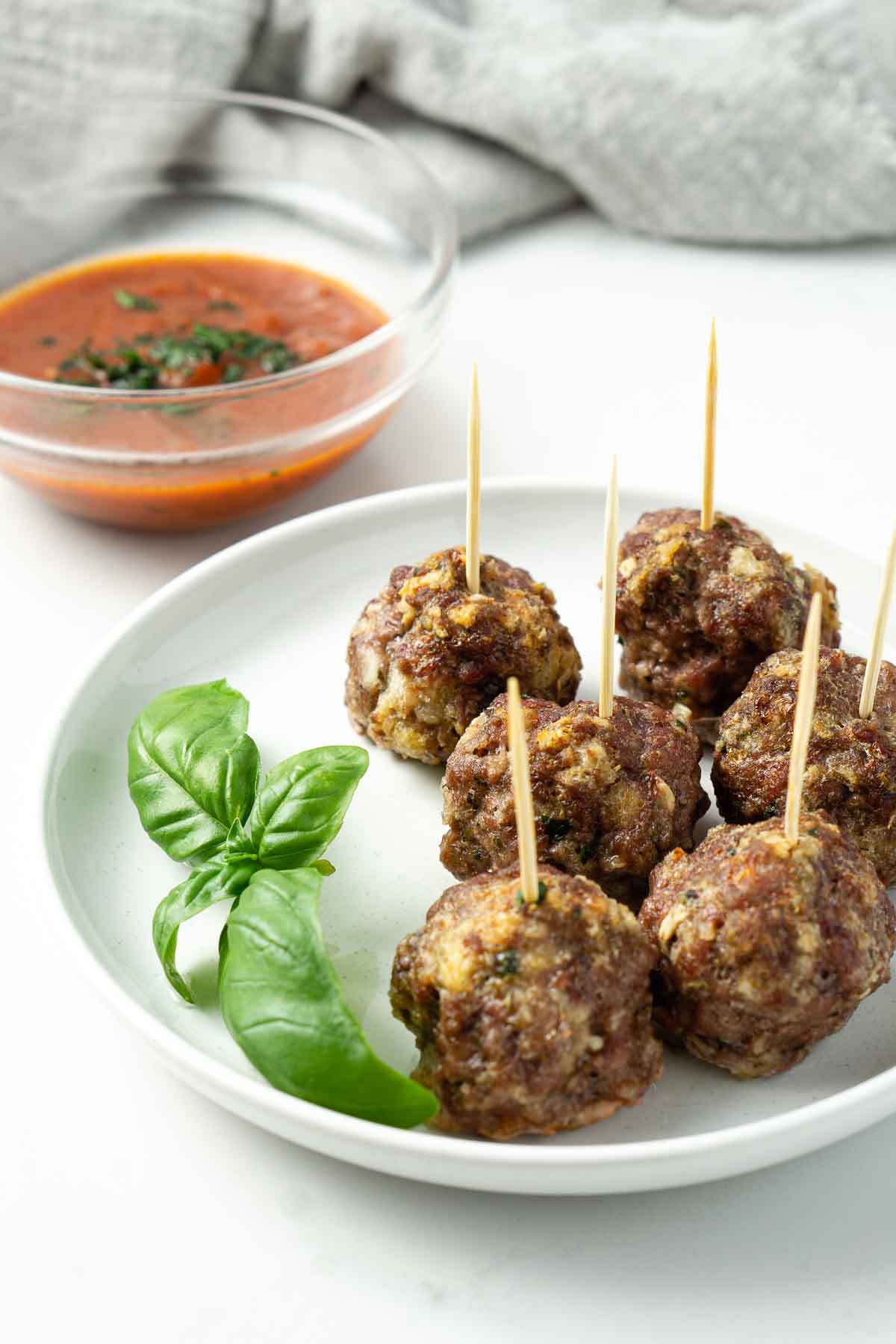 Meatballs served on a plate with toothpicks in them