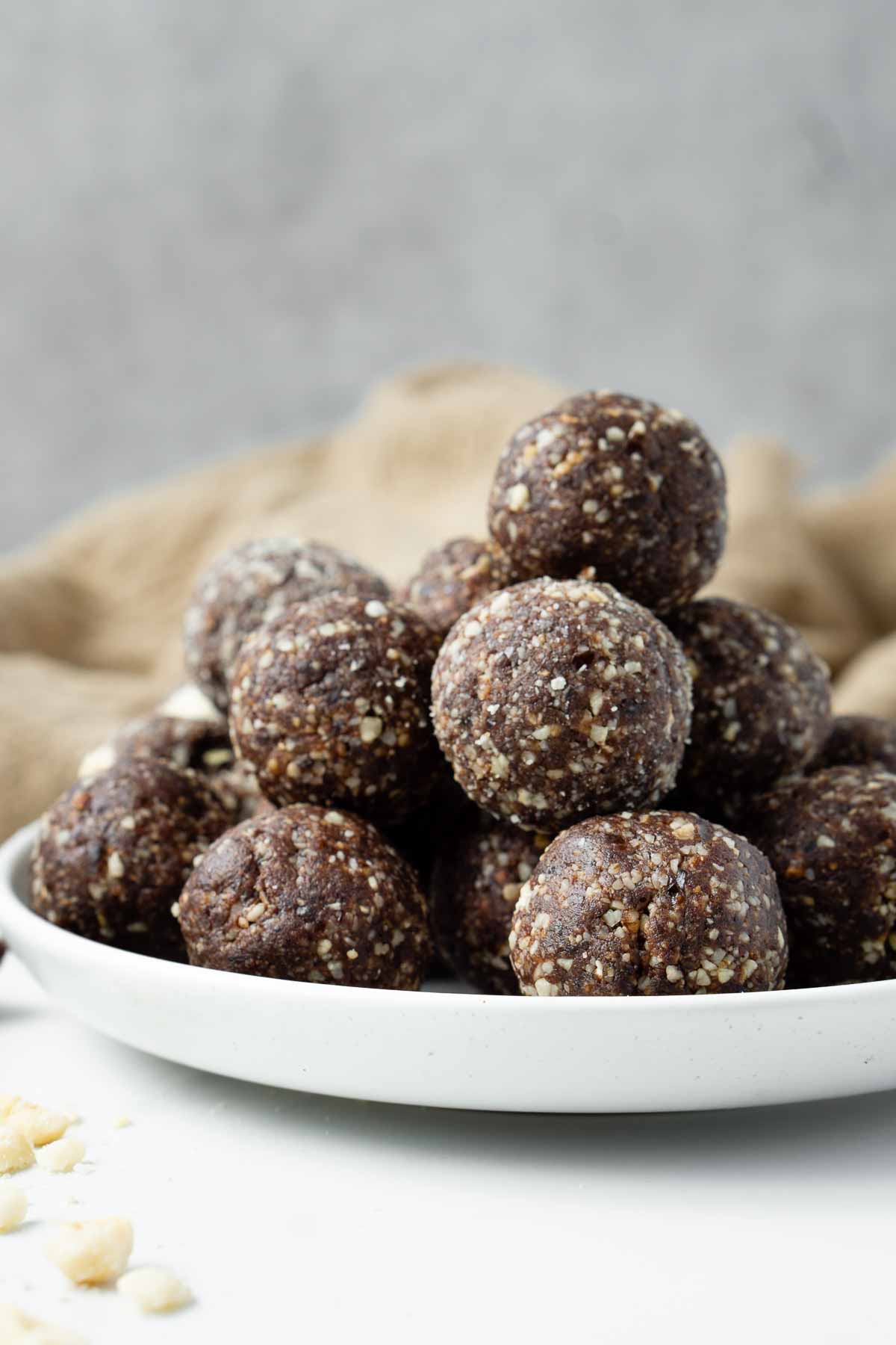 Chocolate Hazelnut Bliss Balls in a pile on a plate ready to eat.