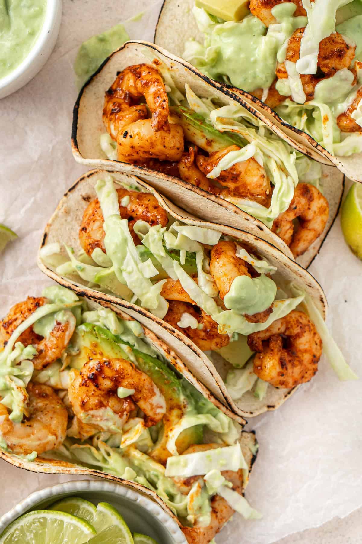 Grilled prawn tacos with slaw and avocado yoghurt sauce served.