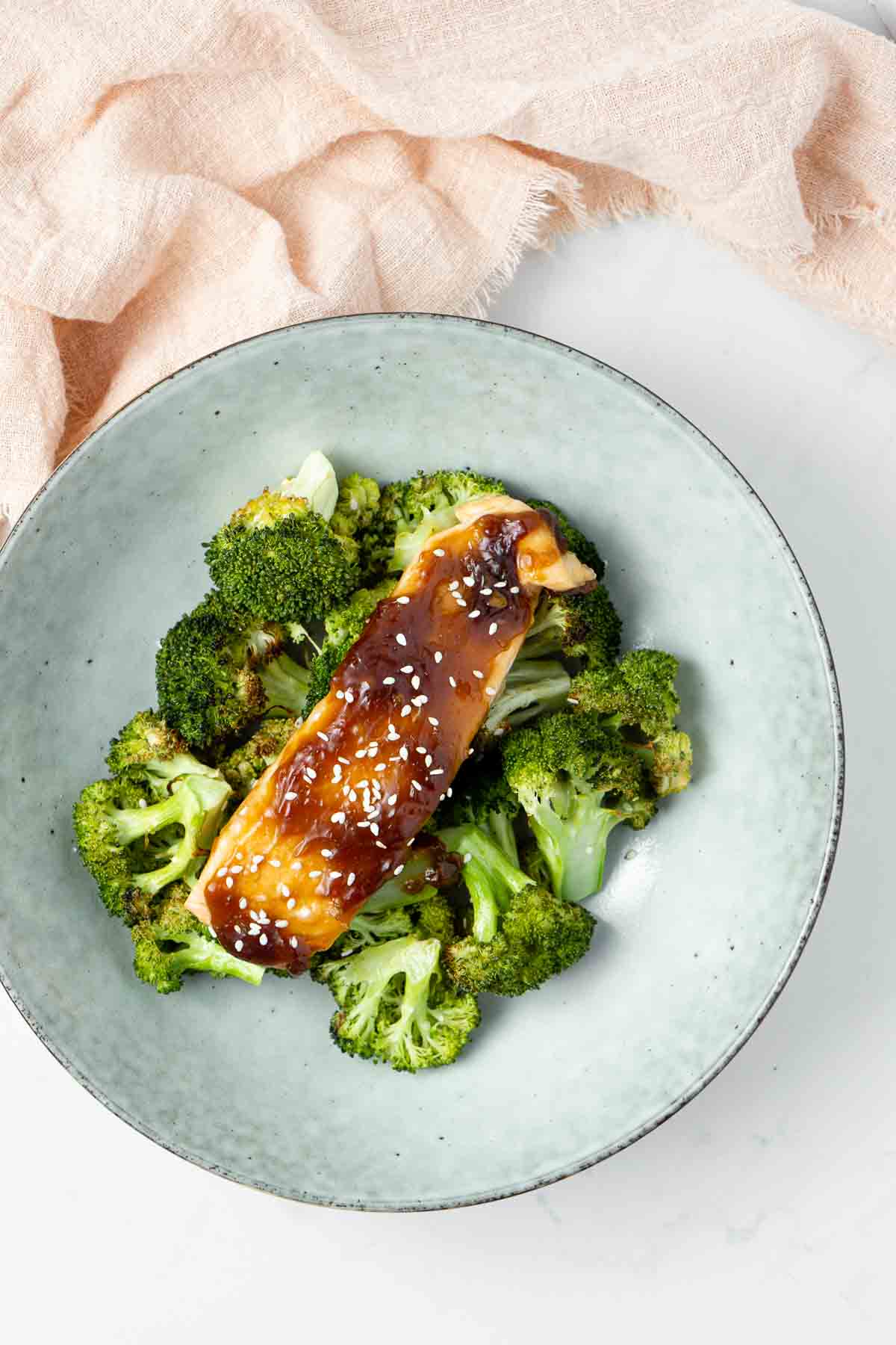 Glazed salmon on a bed of roasted broccoli.