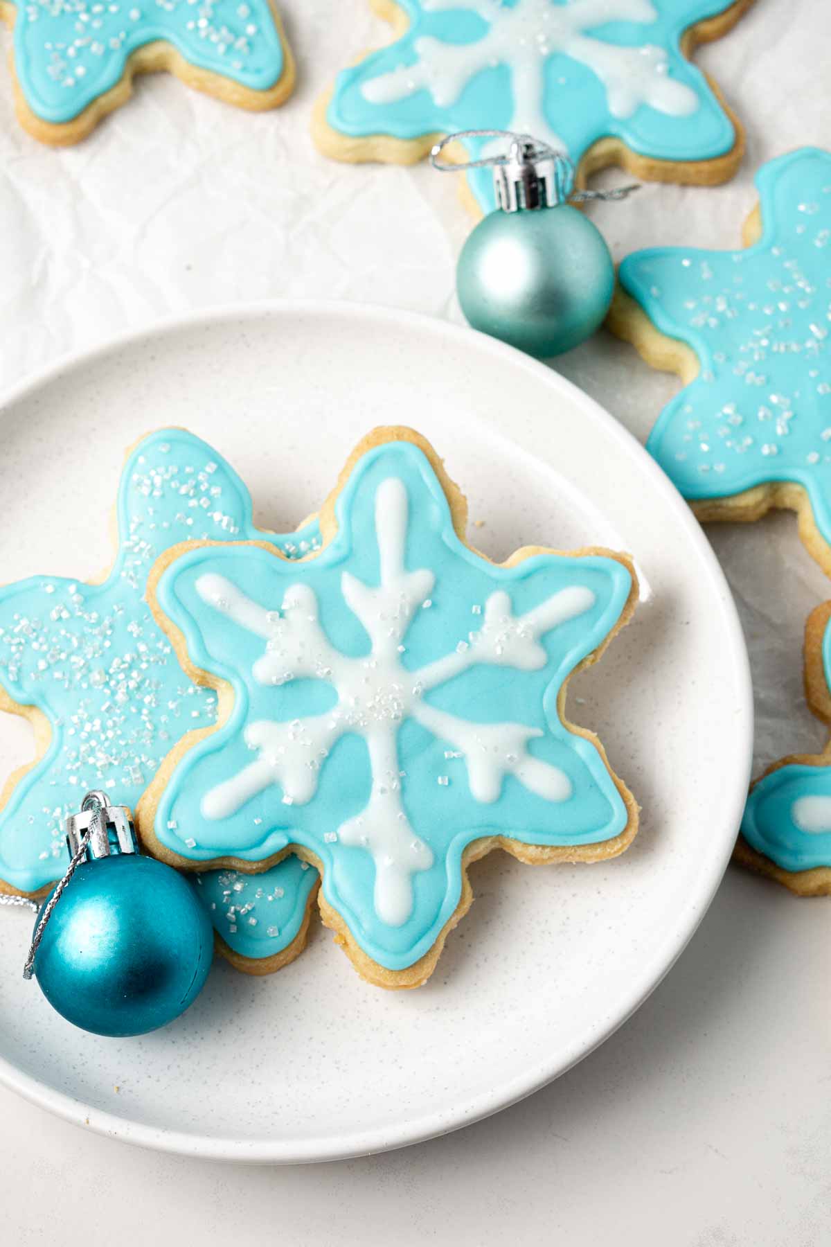 Snowflake decorated sugar cookies on a plate.