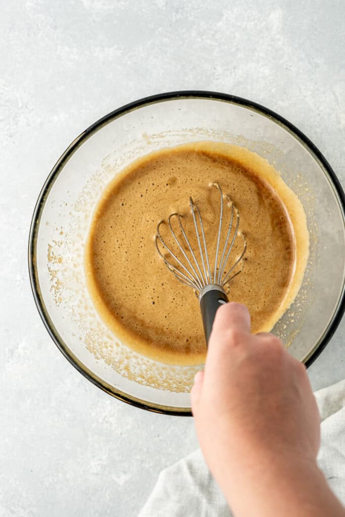 Whisking the wet ingredients in a glass mixing bowl. 