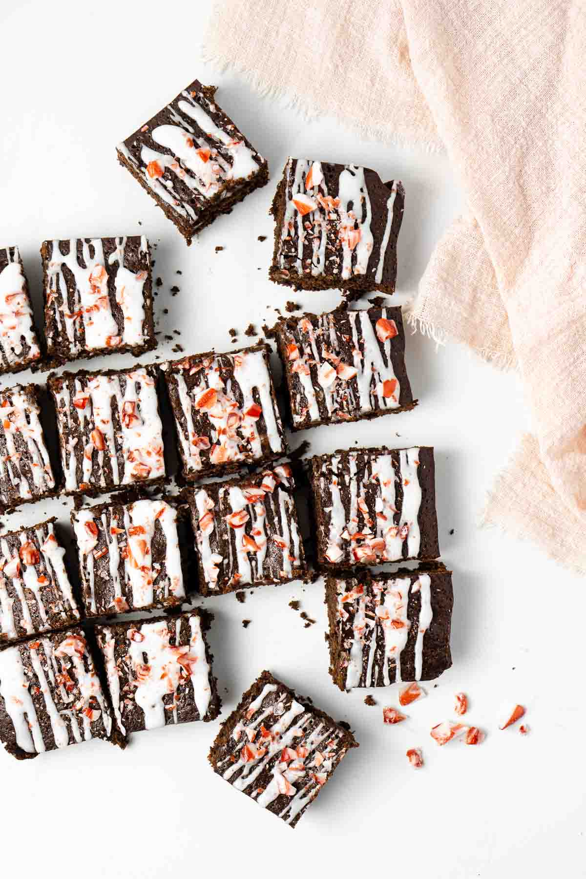 Chocolate peppermint brownies topped with white glaze and crushed candy canes