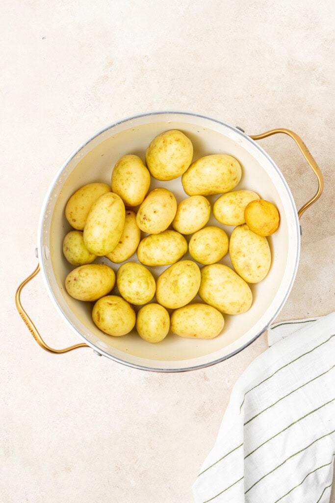 Boiling the potatoes in a large pot.