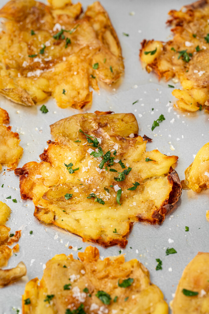 Smashed potato on a baking tray.