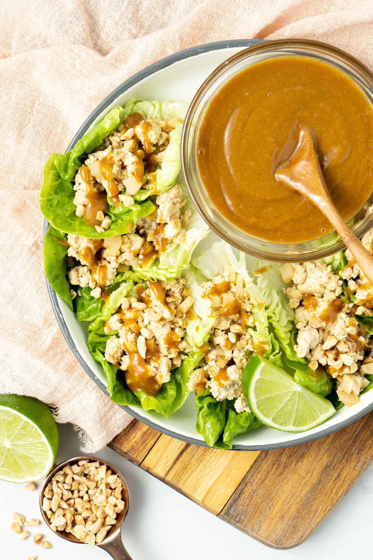 Tofu lettuce cups from above with a bowl of peanut dipping sauce.