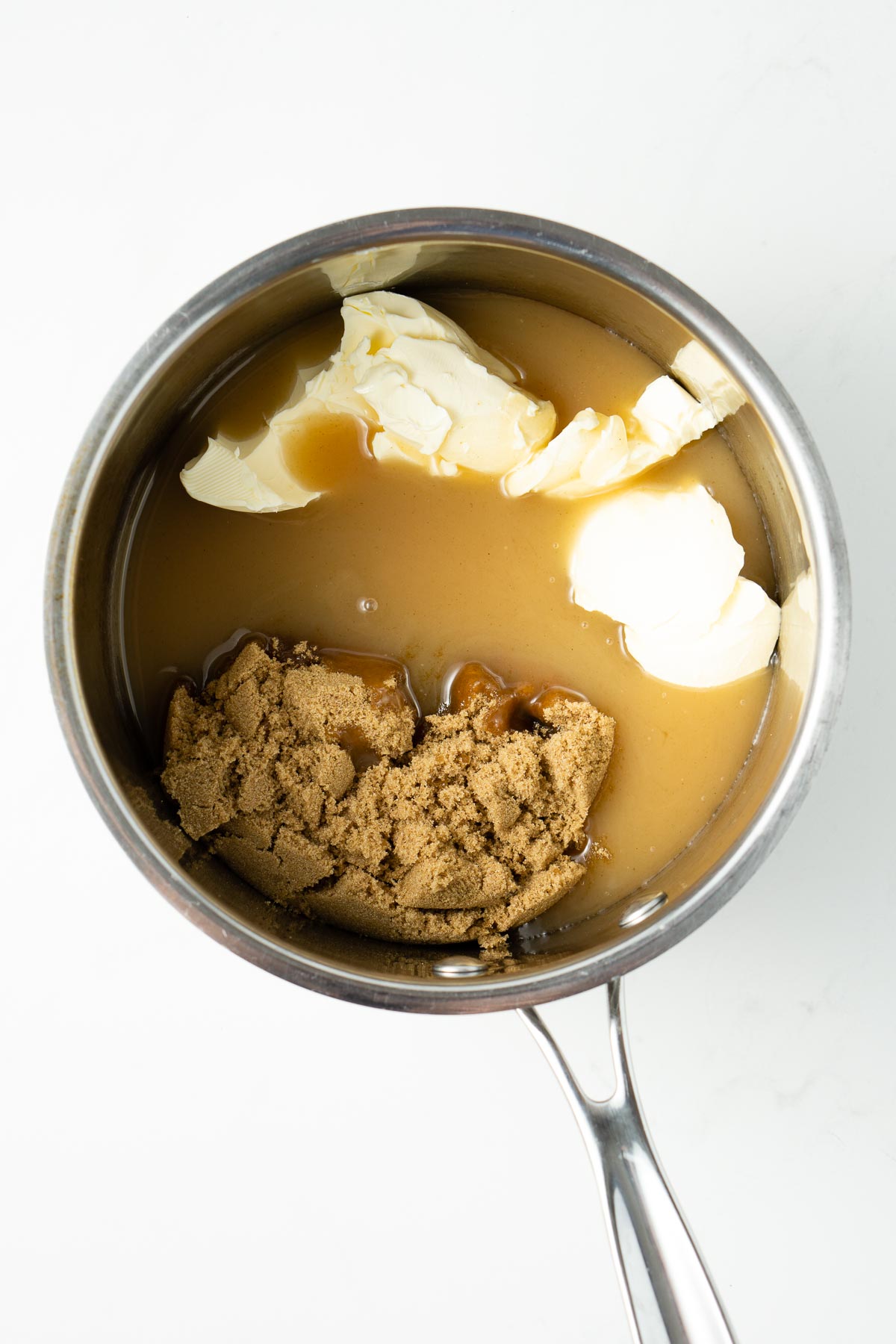 Saucepan with brown sugar, condensed milk and butter.