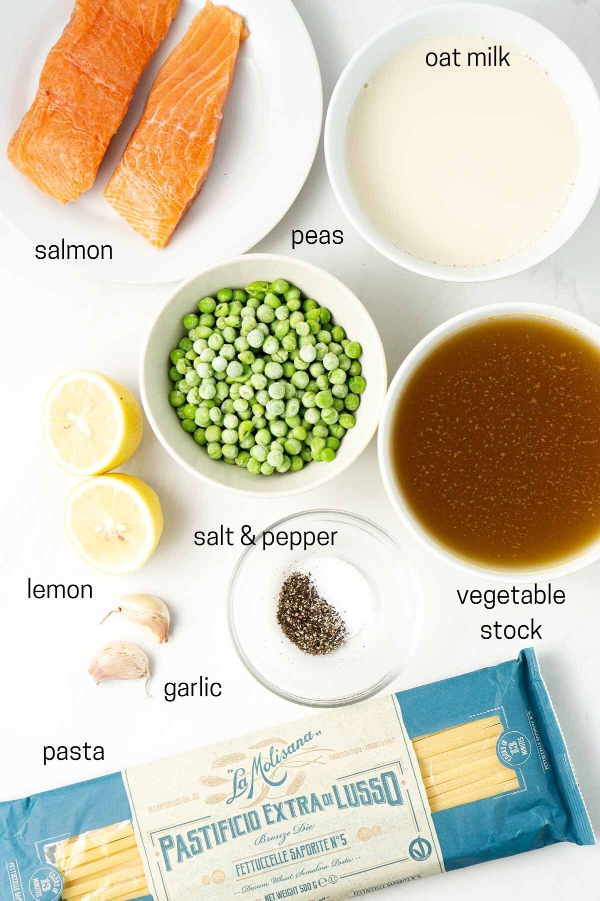Ingredients needed to make creamy salmon tagliatelle laid out in small bowls.