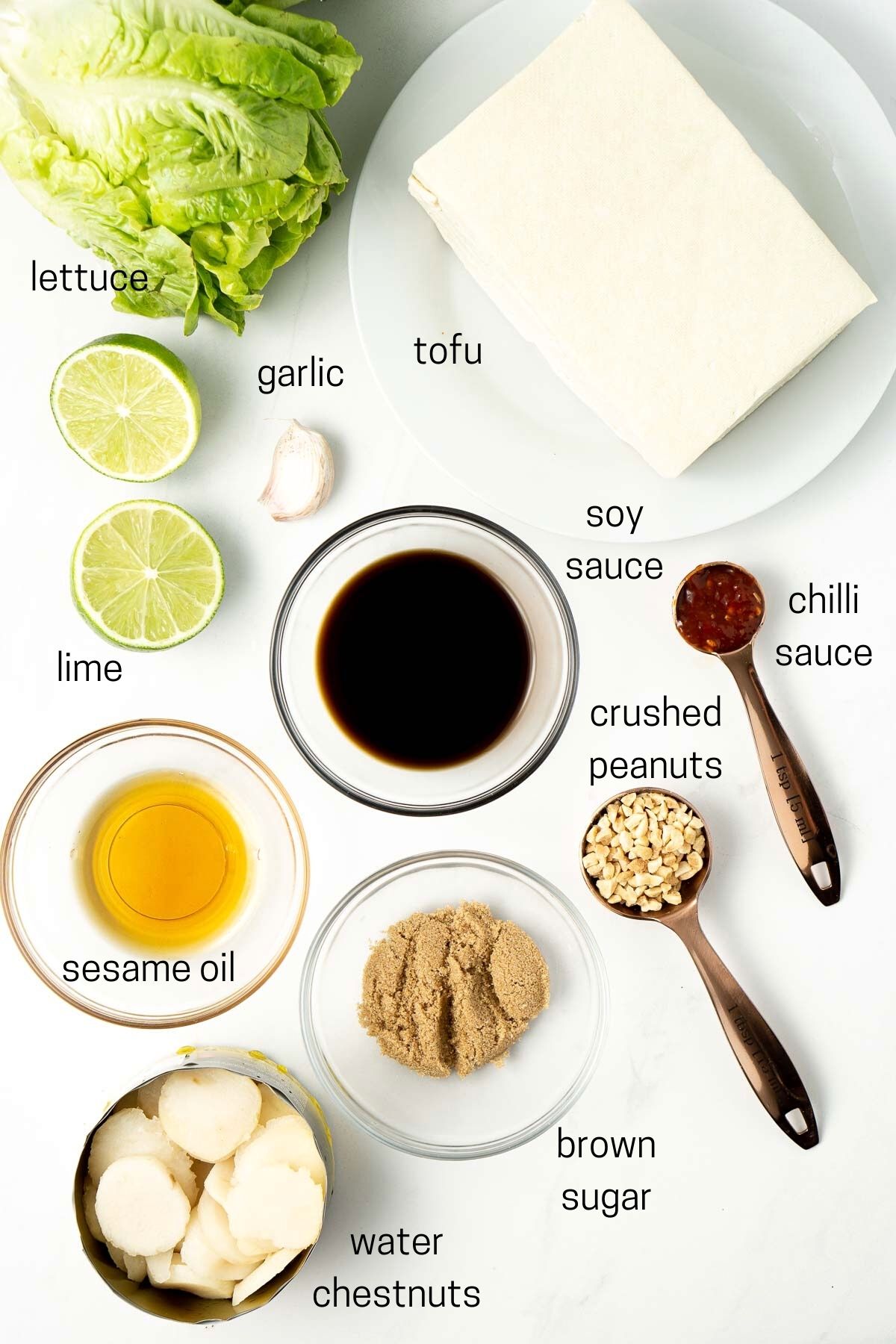 All ingredients needed for tofu lettuce cups laid out in small bowls.