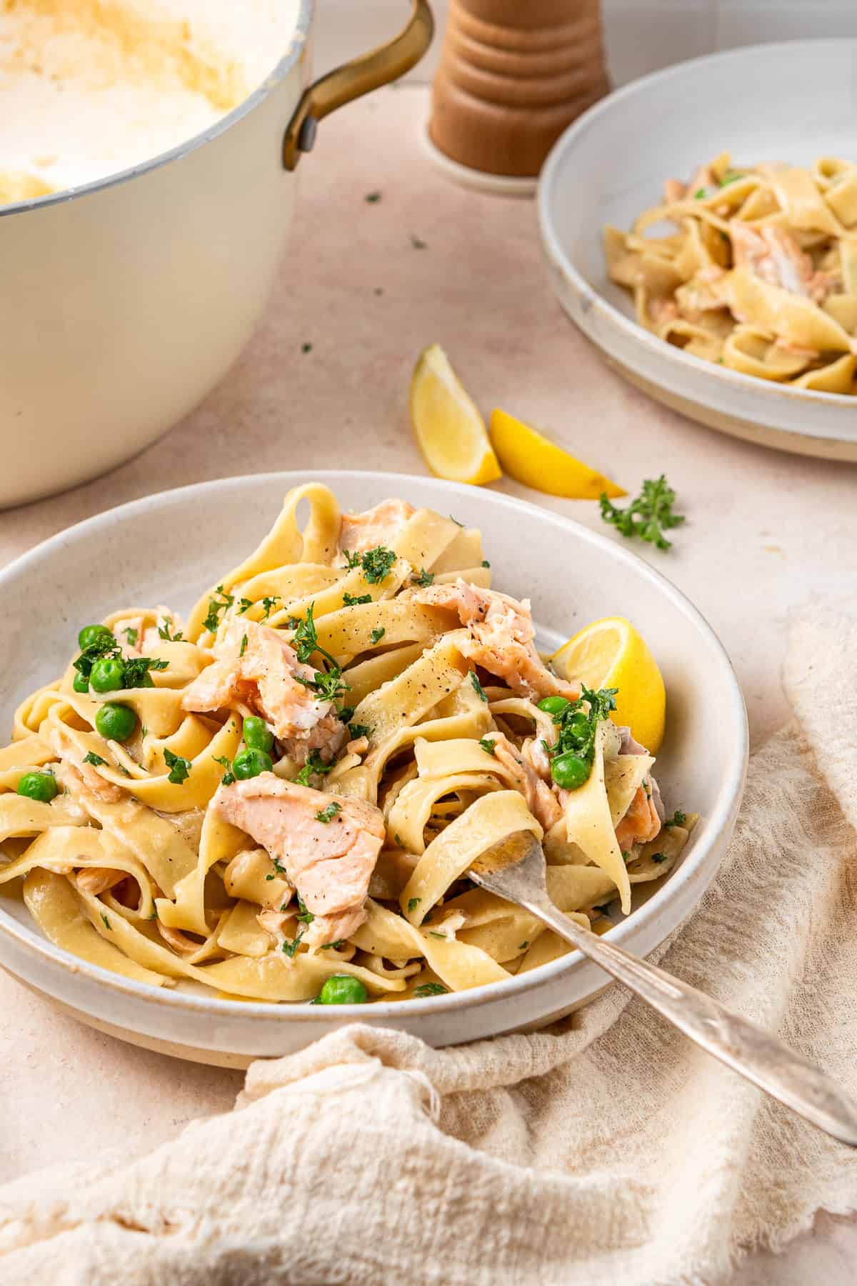 A plate of creamy salmon pasta without cream with a fork.