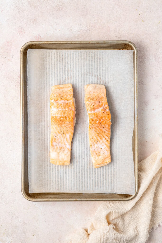 Oven baked salmon on a baking tray.