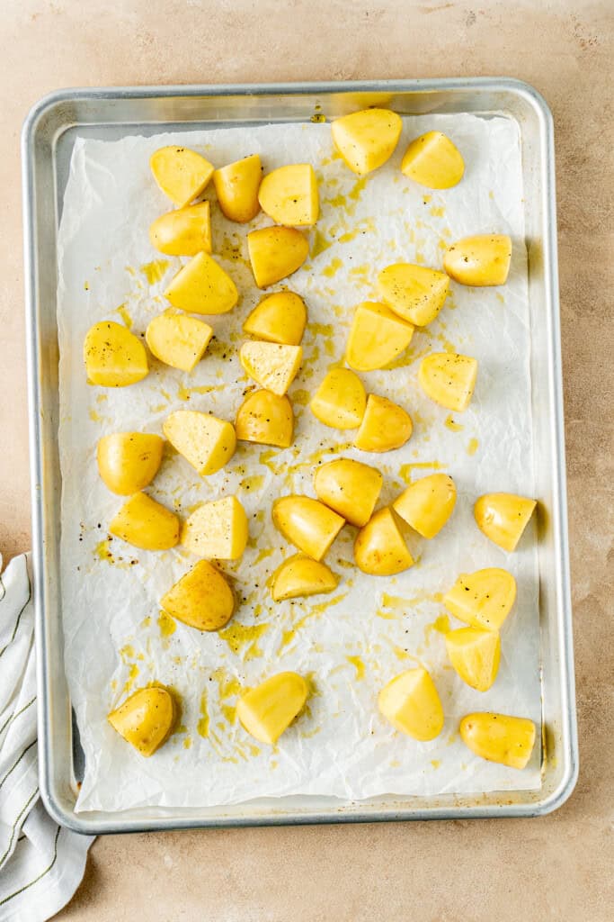 The potatoes on a baking tray.