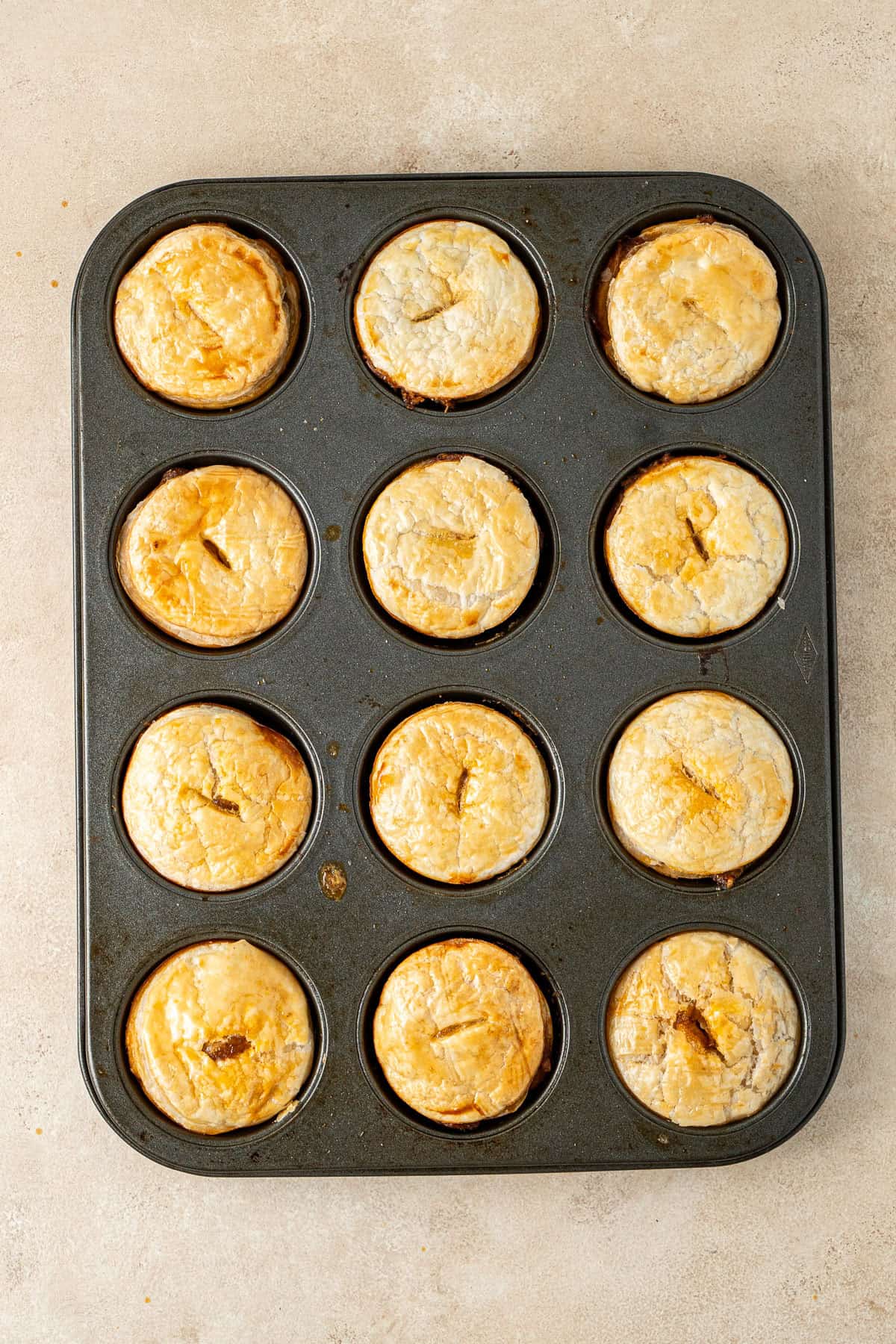 The cooked party pies in the muffin tin.