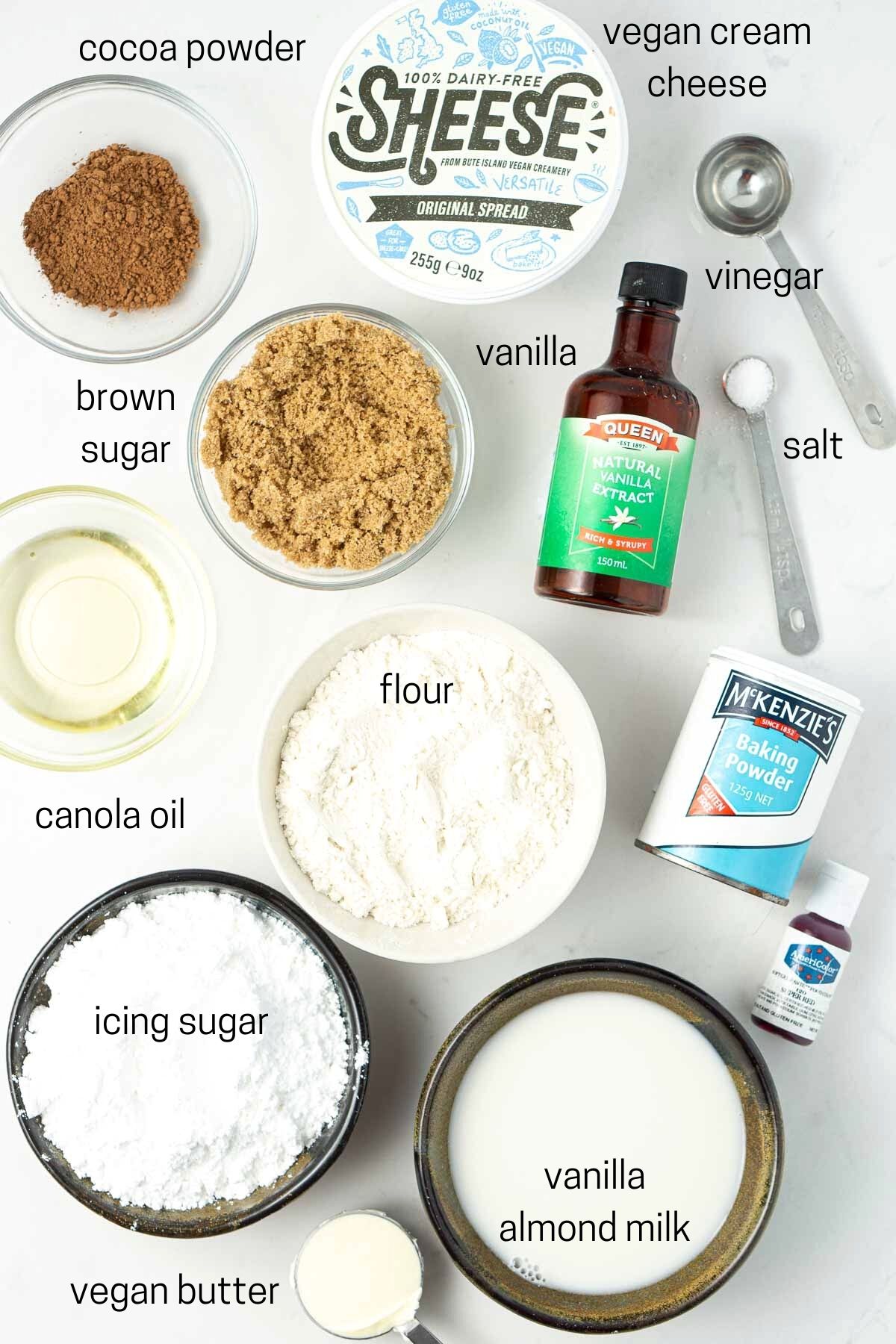 All of the ingredients for baked red velvet doughnuts laid out read to make.
