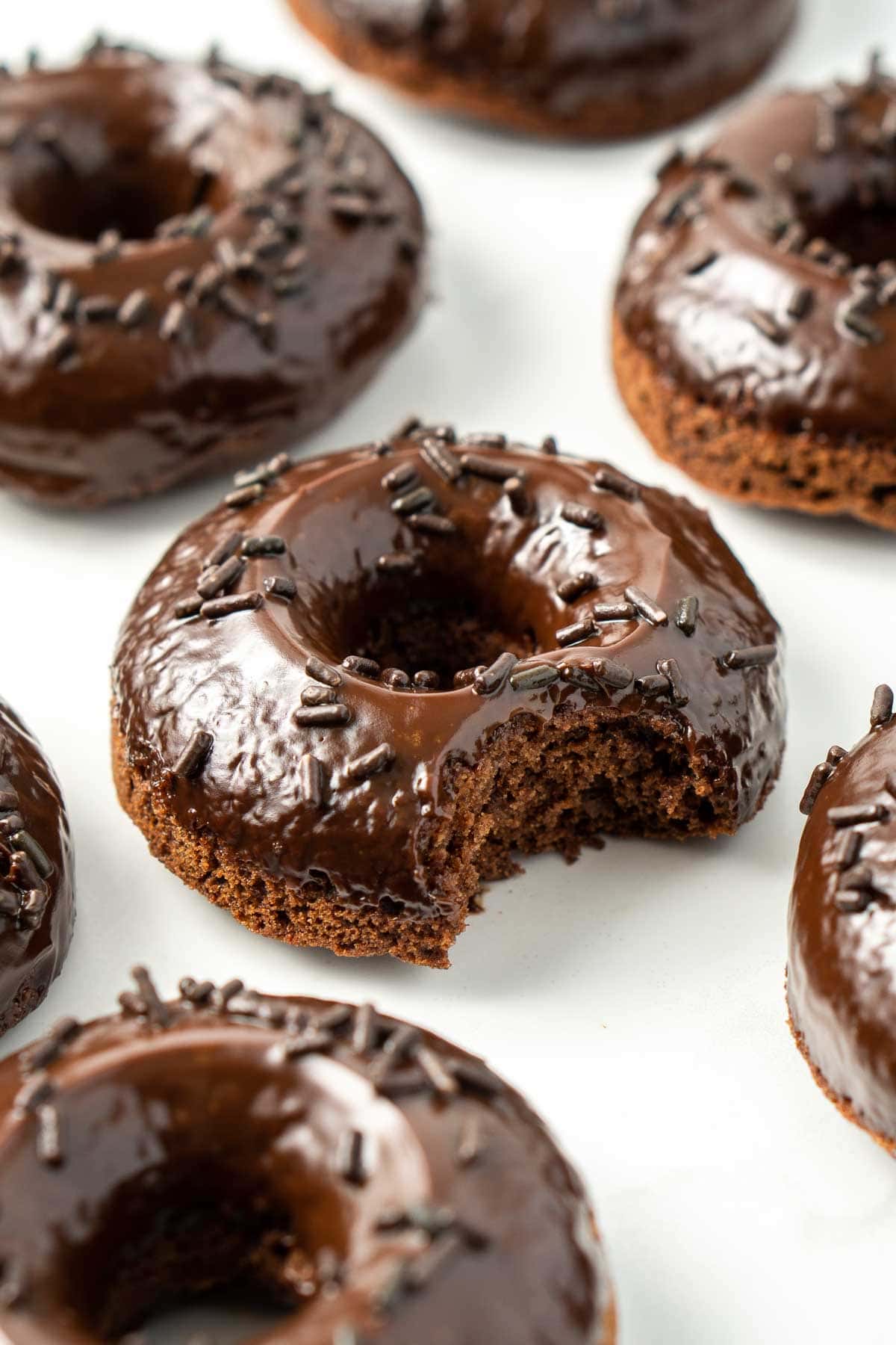 Close up of dairy-free doughnuts with a bite taken out of it.