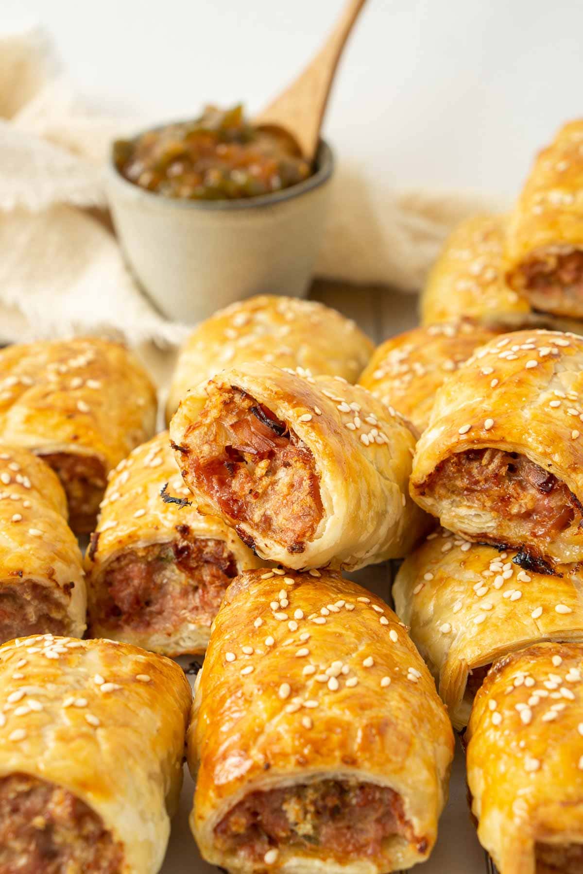 Close up of cooked gourmet sausage rolls with golden brown, flaky pastry. 