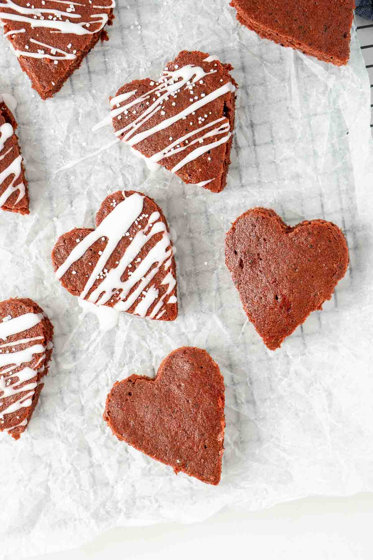 heart shaped red velvet brownies on a cooling rack.