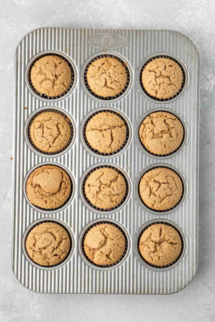 Freshly baked cupcakes in a muffin pan.