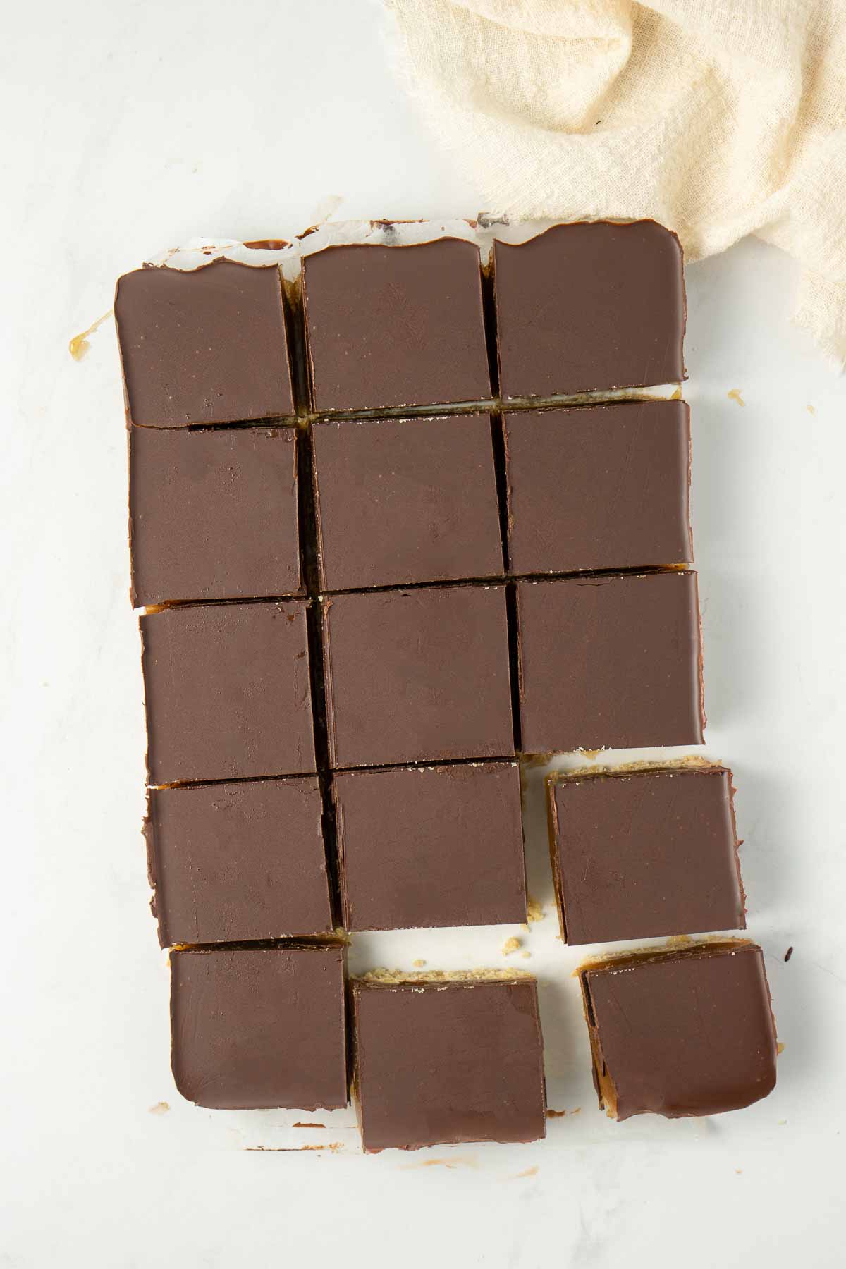 Caramel slice or vegan millionaire's shortbread cut into squares from above.