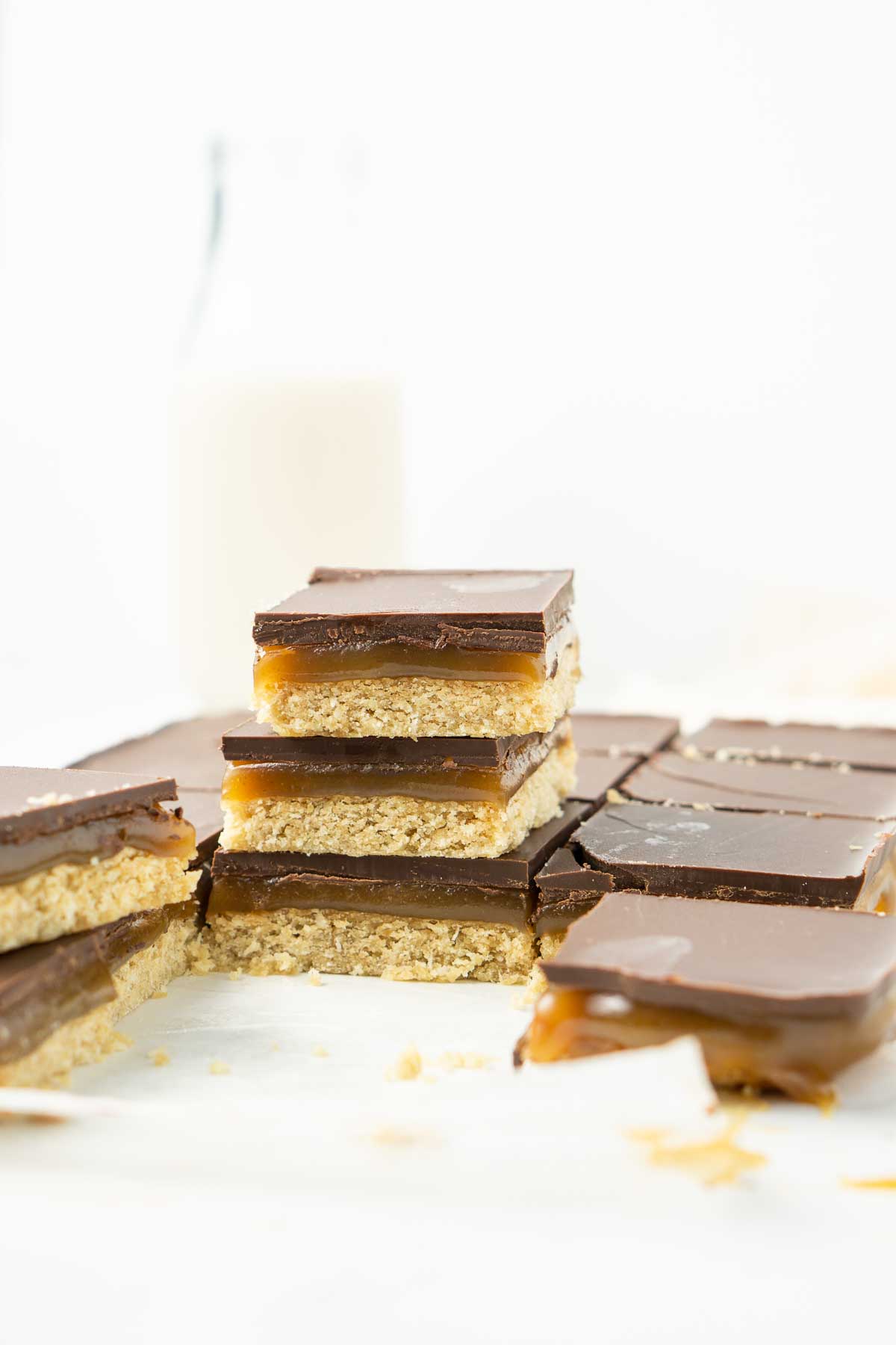 Three pieces of vegan caramel slice staked up.