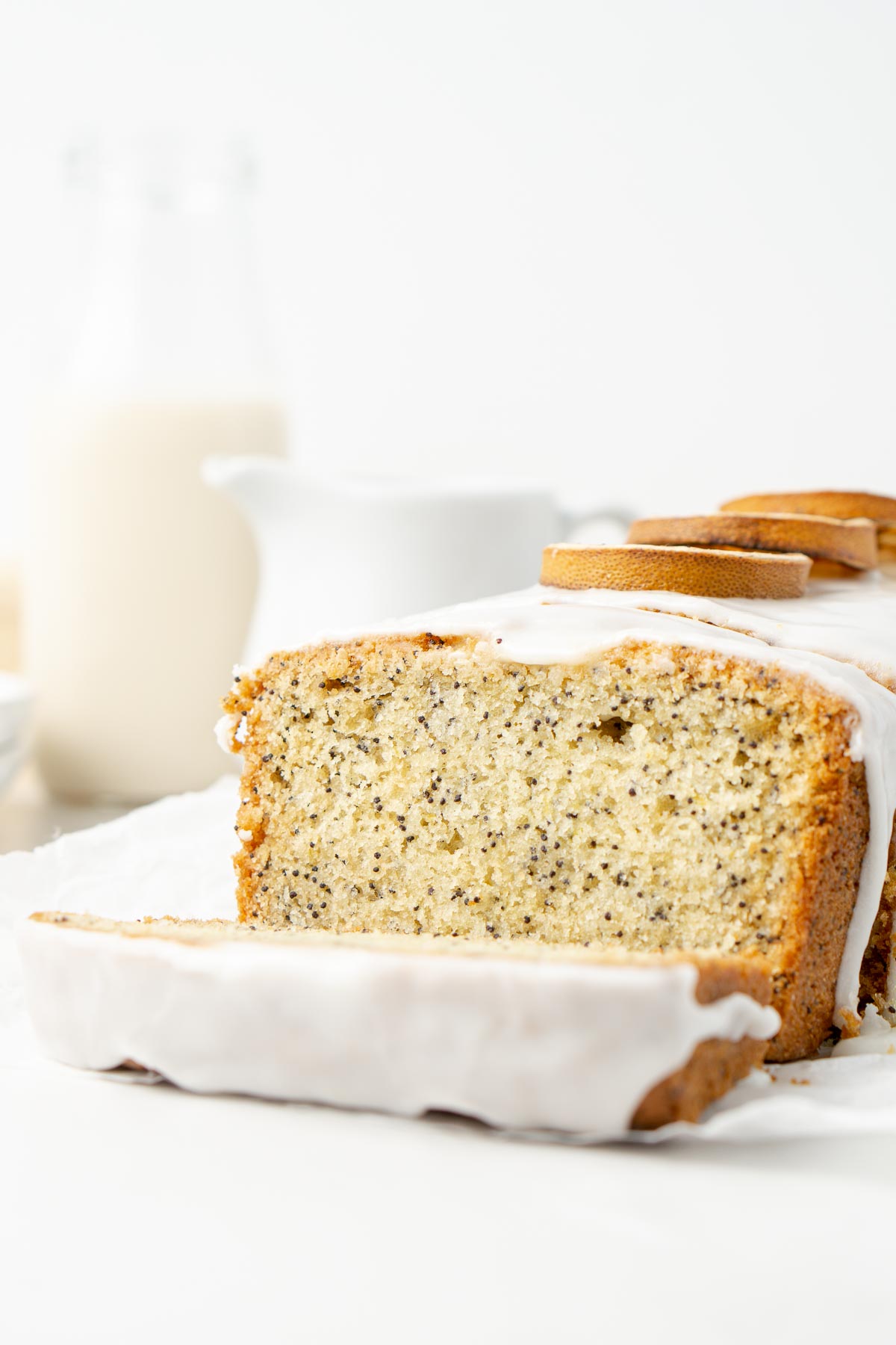A close up of lemon poppyseed cake cut into slices.