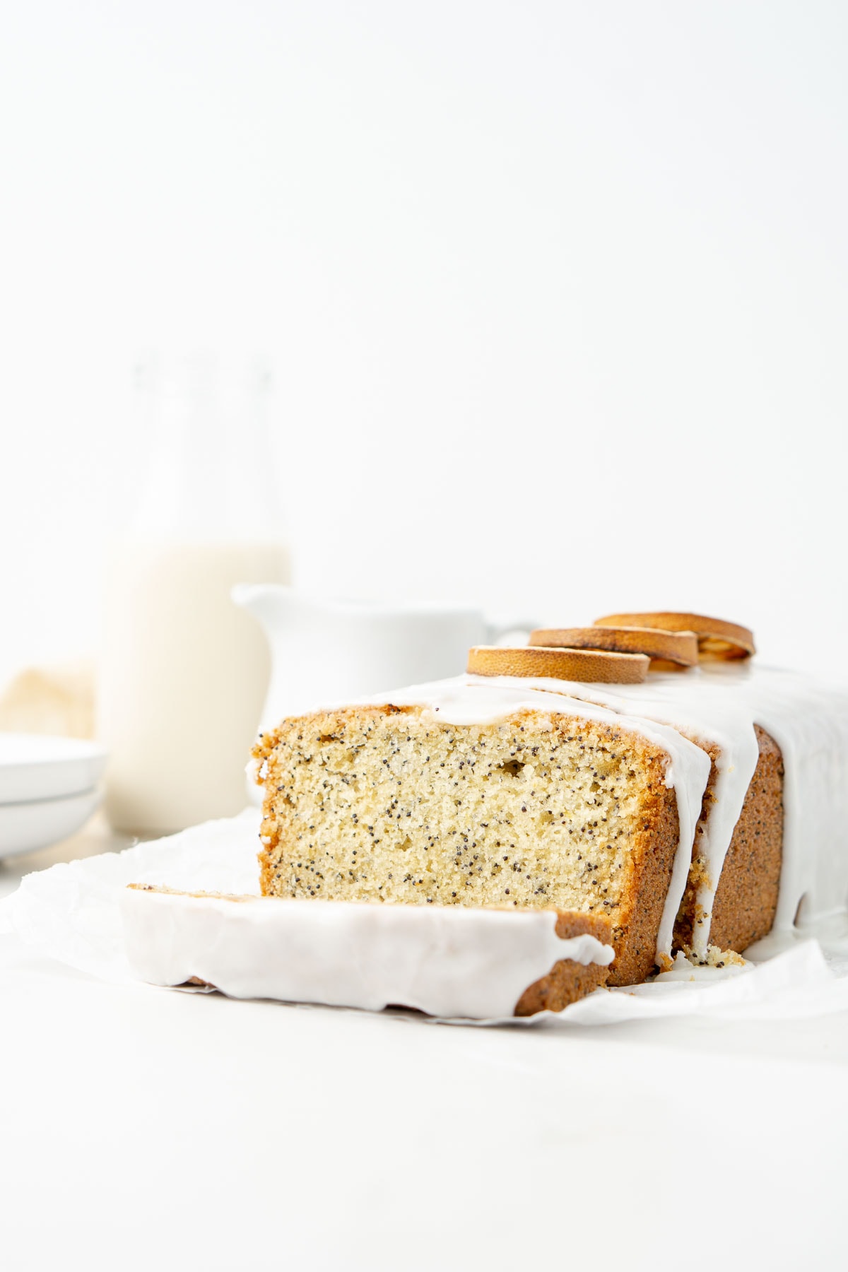 Lemon and poppy seed cake with slices cut with white lemon icing. 