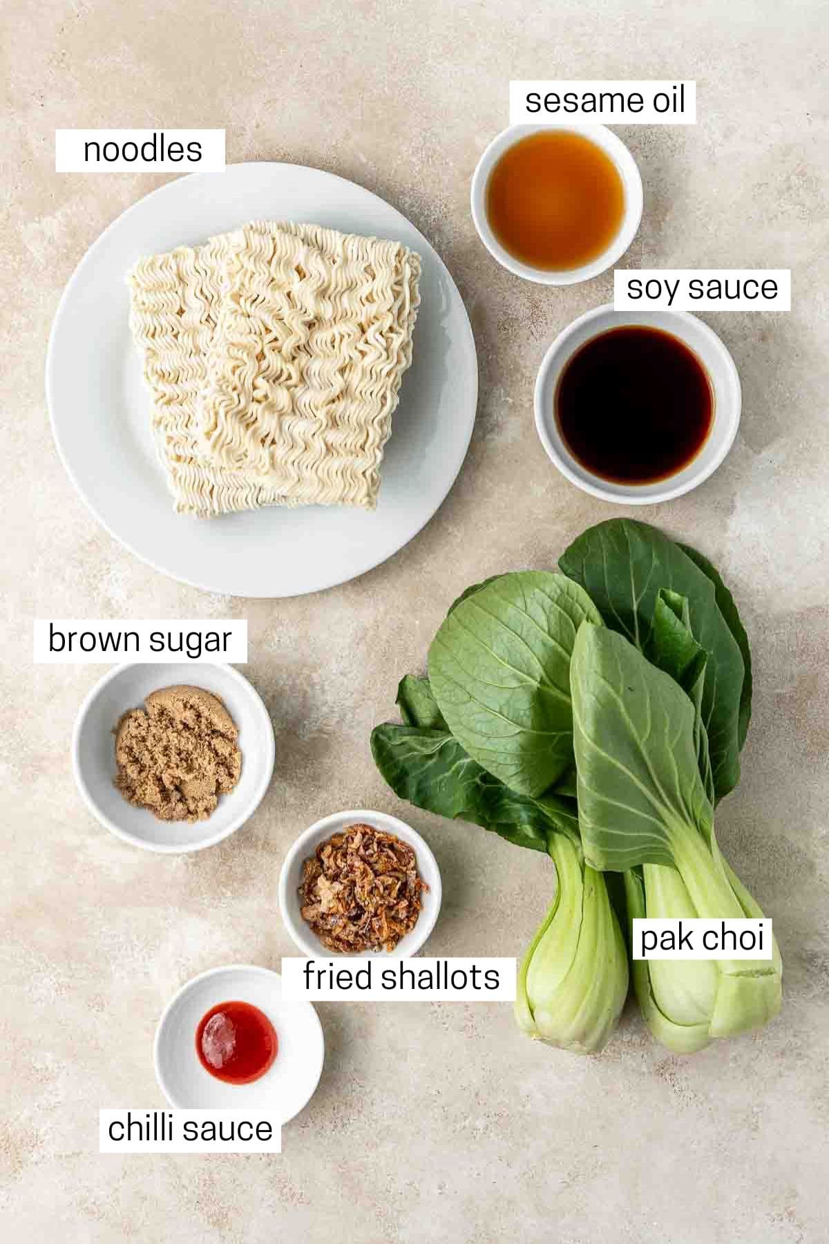 All ingredients needed to make sweet and spicy noodles in small bowls.