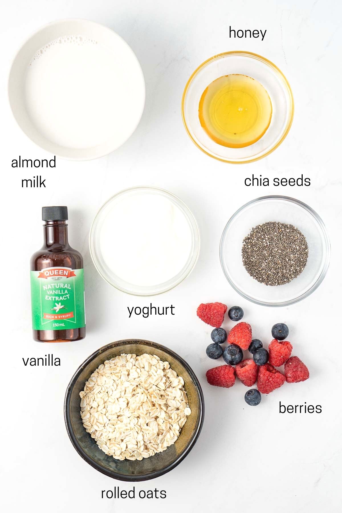 All ingredients needed for overnight oats laid out in small bowls.