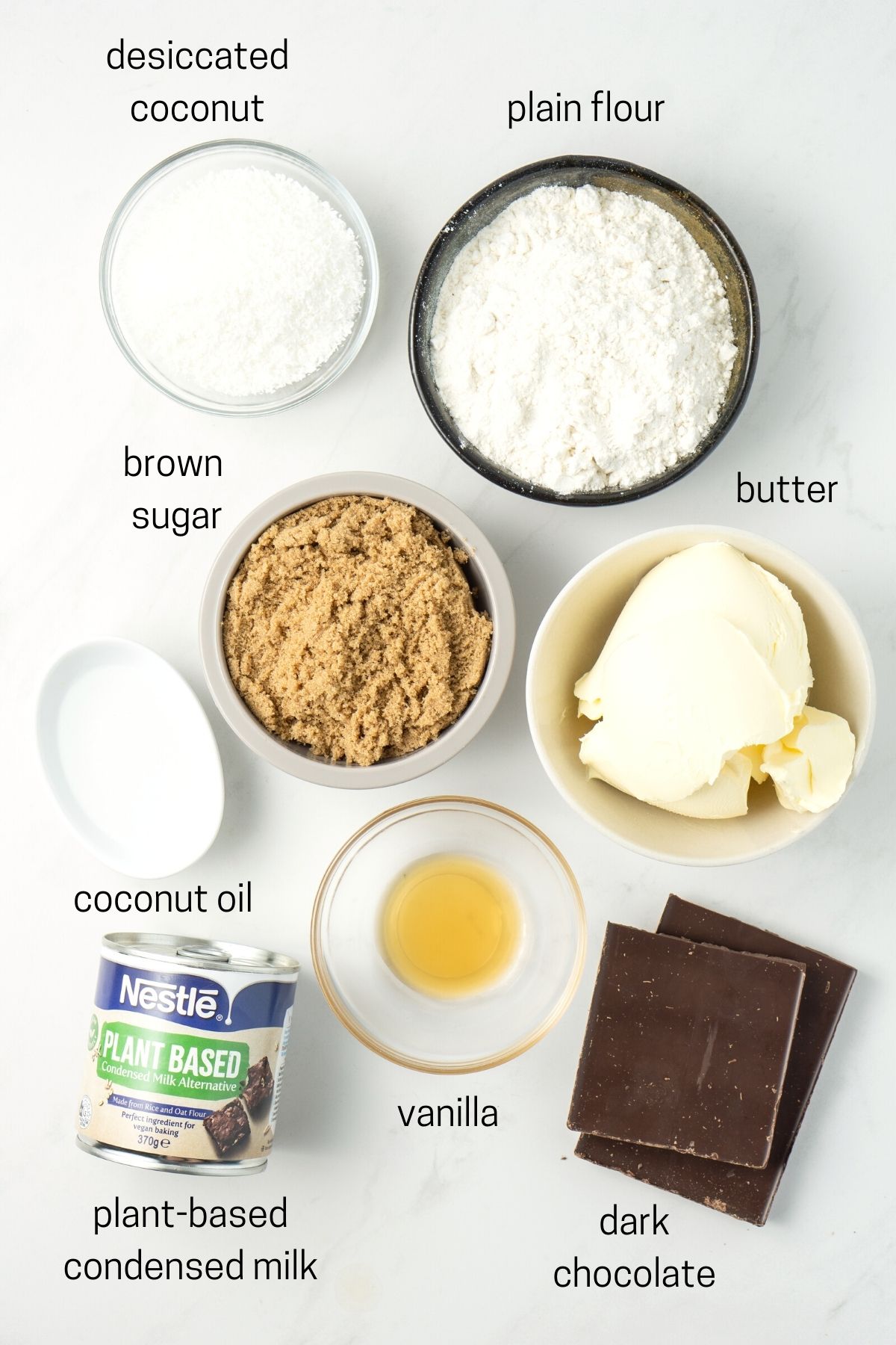 All ingredients needed for vegan caramel slice laud out in small bowls.