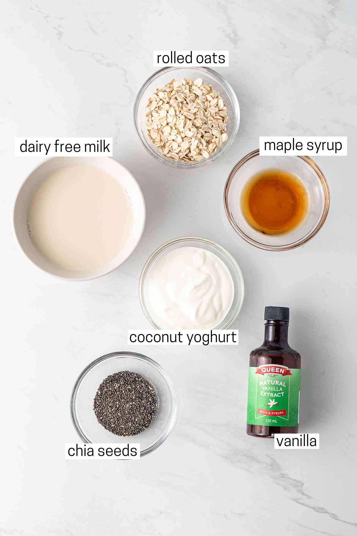 All ingredients needed for overnight oats laid out in small bowls.