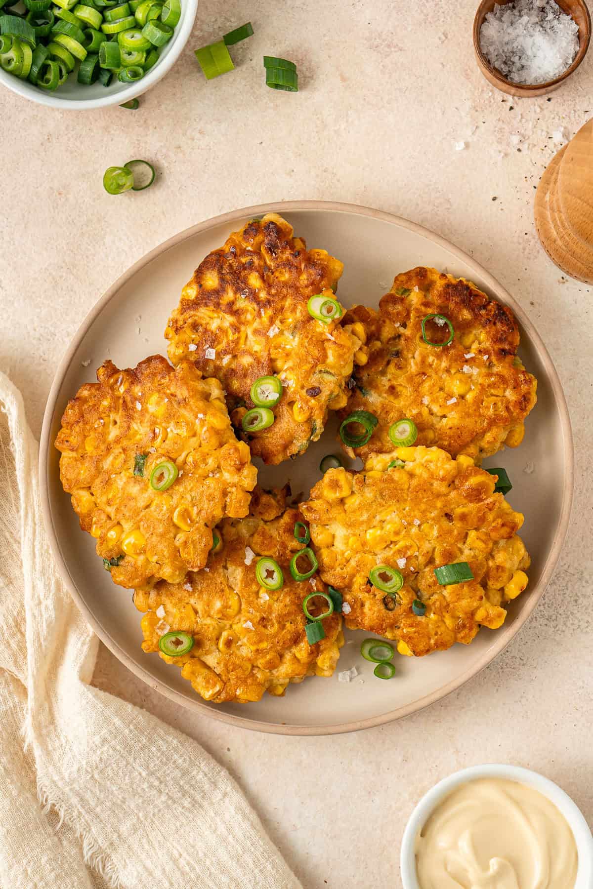 The cooked corn fritters served on a plate.