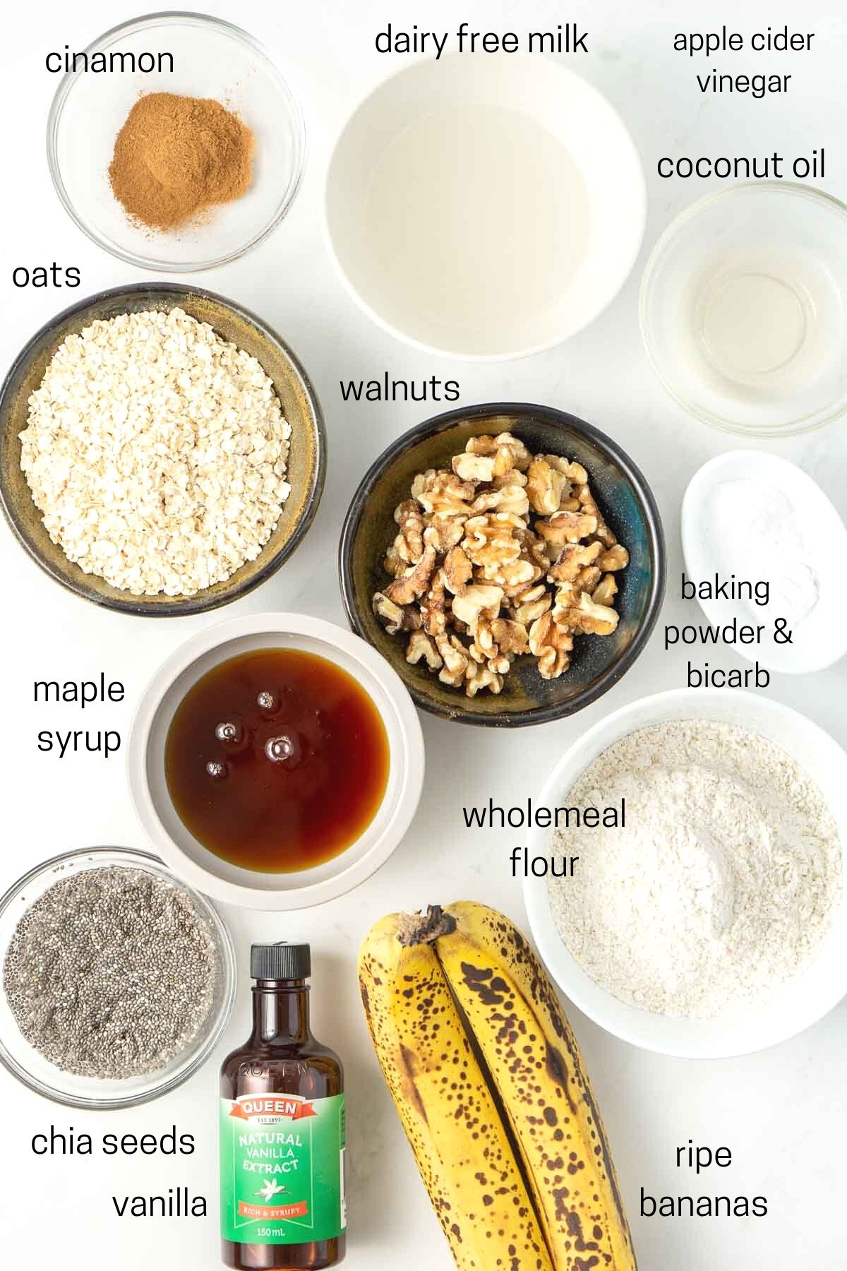 All ingredients needed to make the muffins laid out in small bowls.