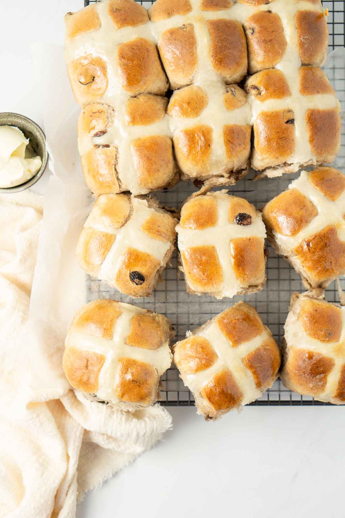 Hot cross buns on a wire cooling rack. 