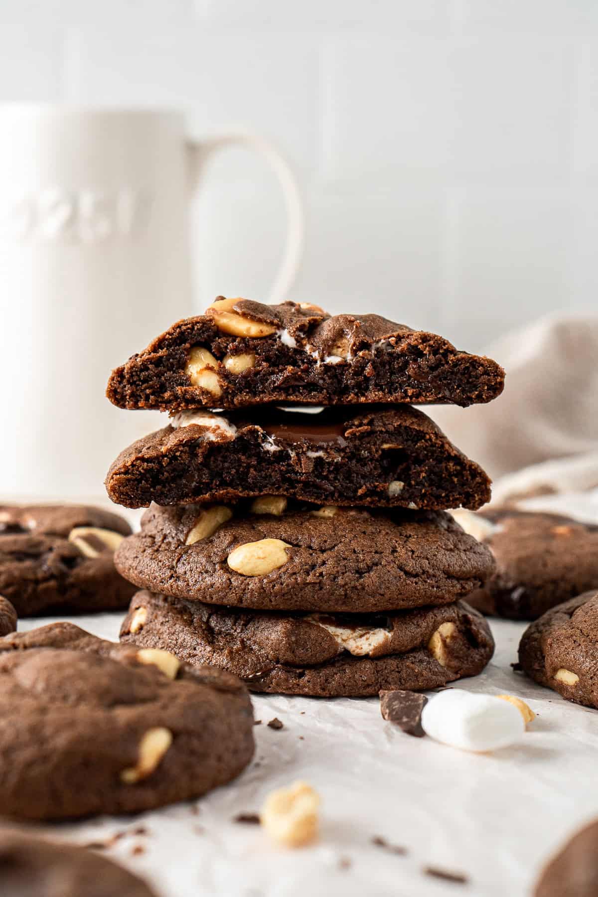 A stack of rocky road cookies, one cut in half showing the middle.