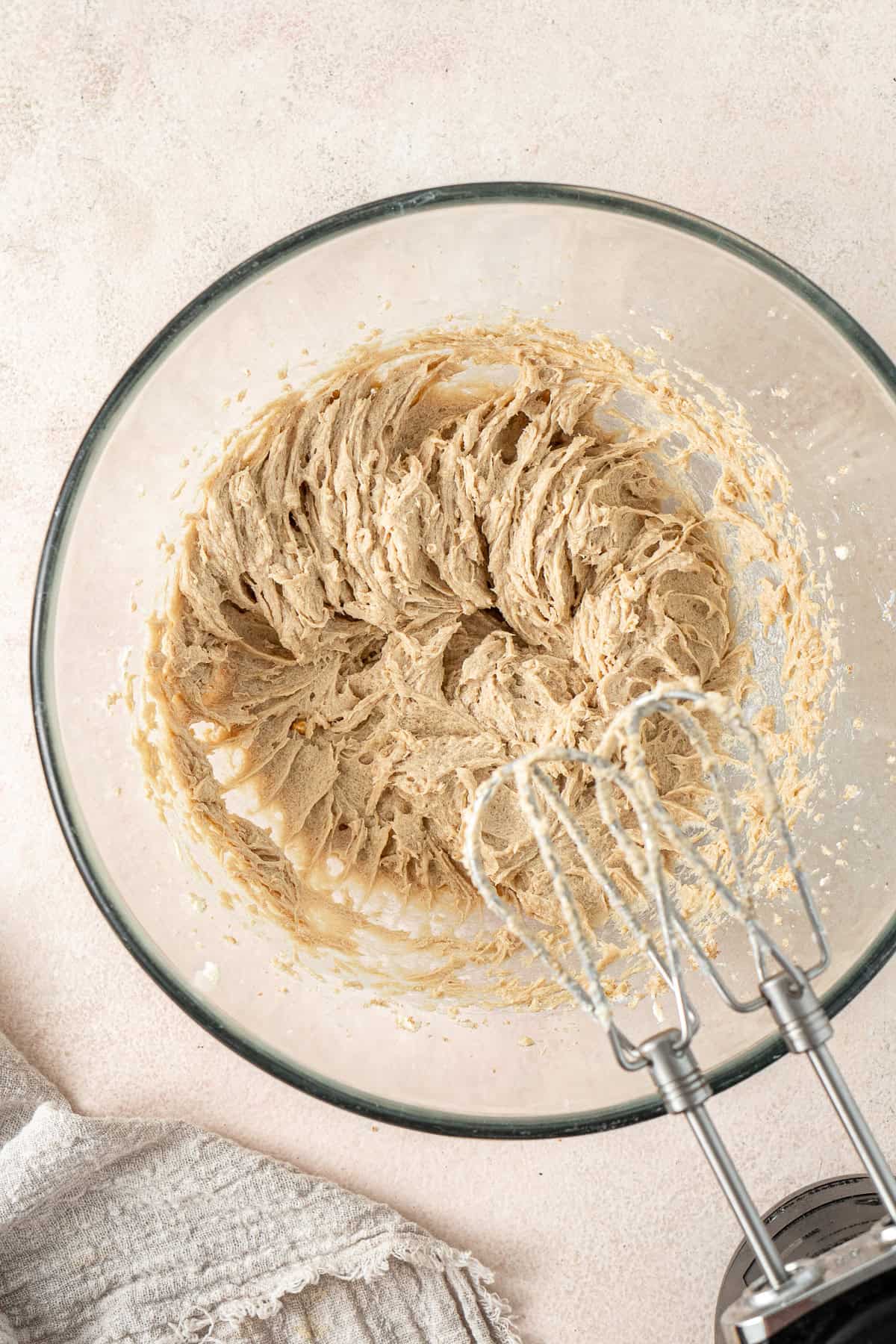 Beating together the wet ingredients in a glass bowl.