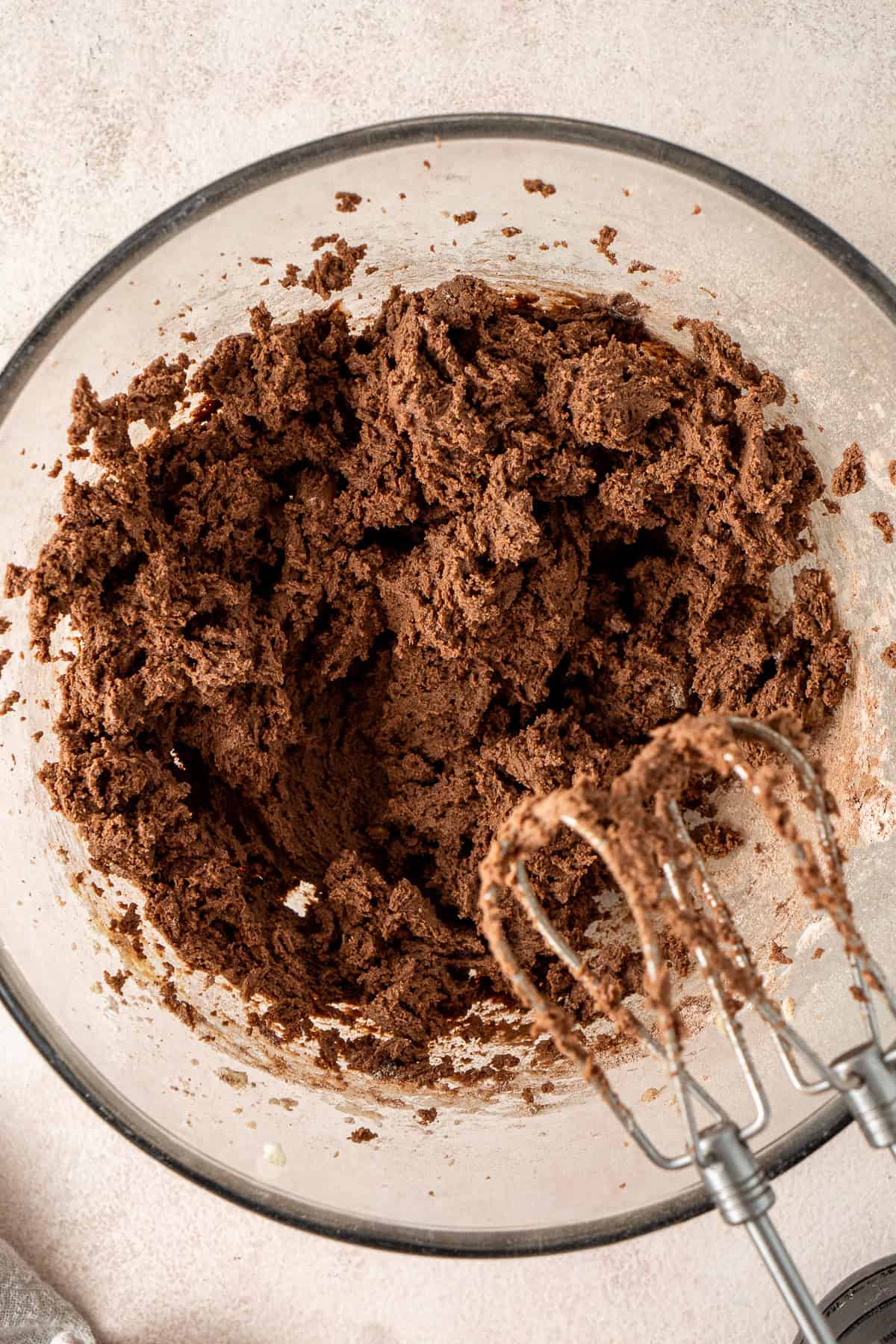 The chocolate cookie dough mixed together in a glass bowl.