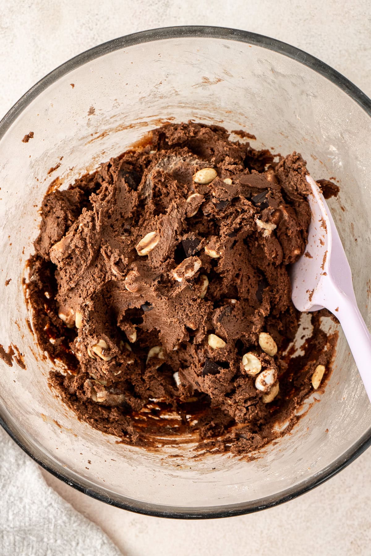 Mixing through the mix ins to the cookie dough in the bowl.