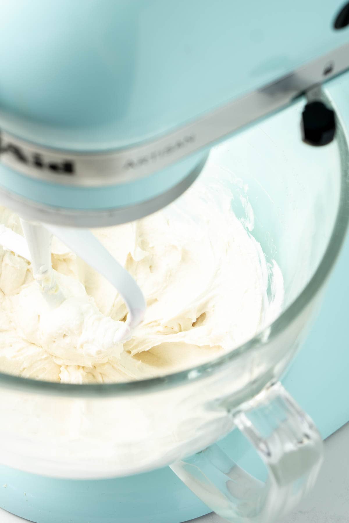 Kitchen aid stand mixer with creamy vegan cream cheese frosting.