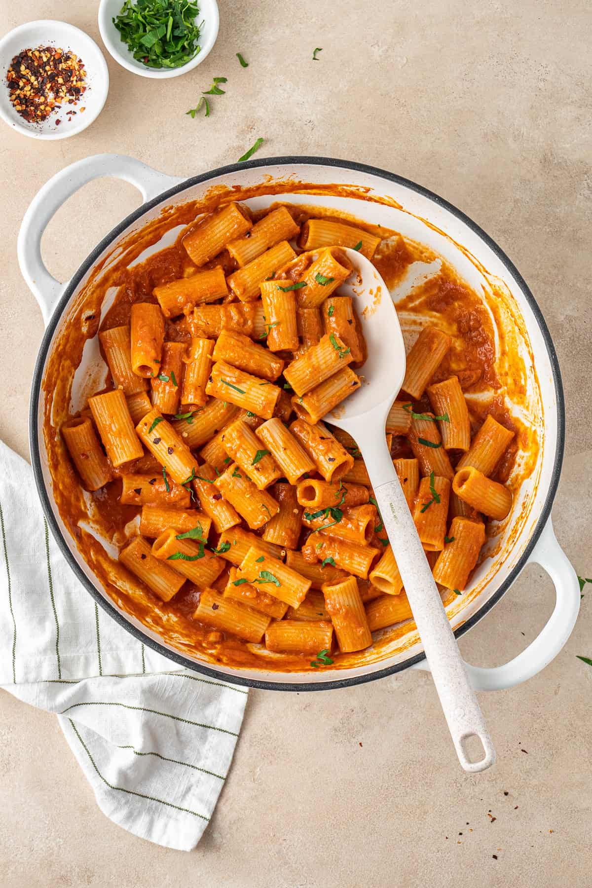A pot of vodka pasta with a spoon.