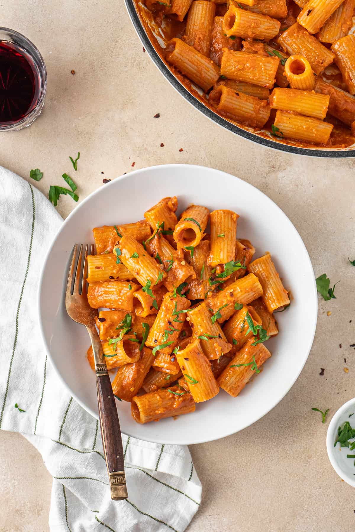 The vegan vodka pasta served into a bowl with fresh parsley.