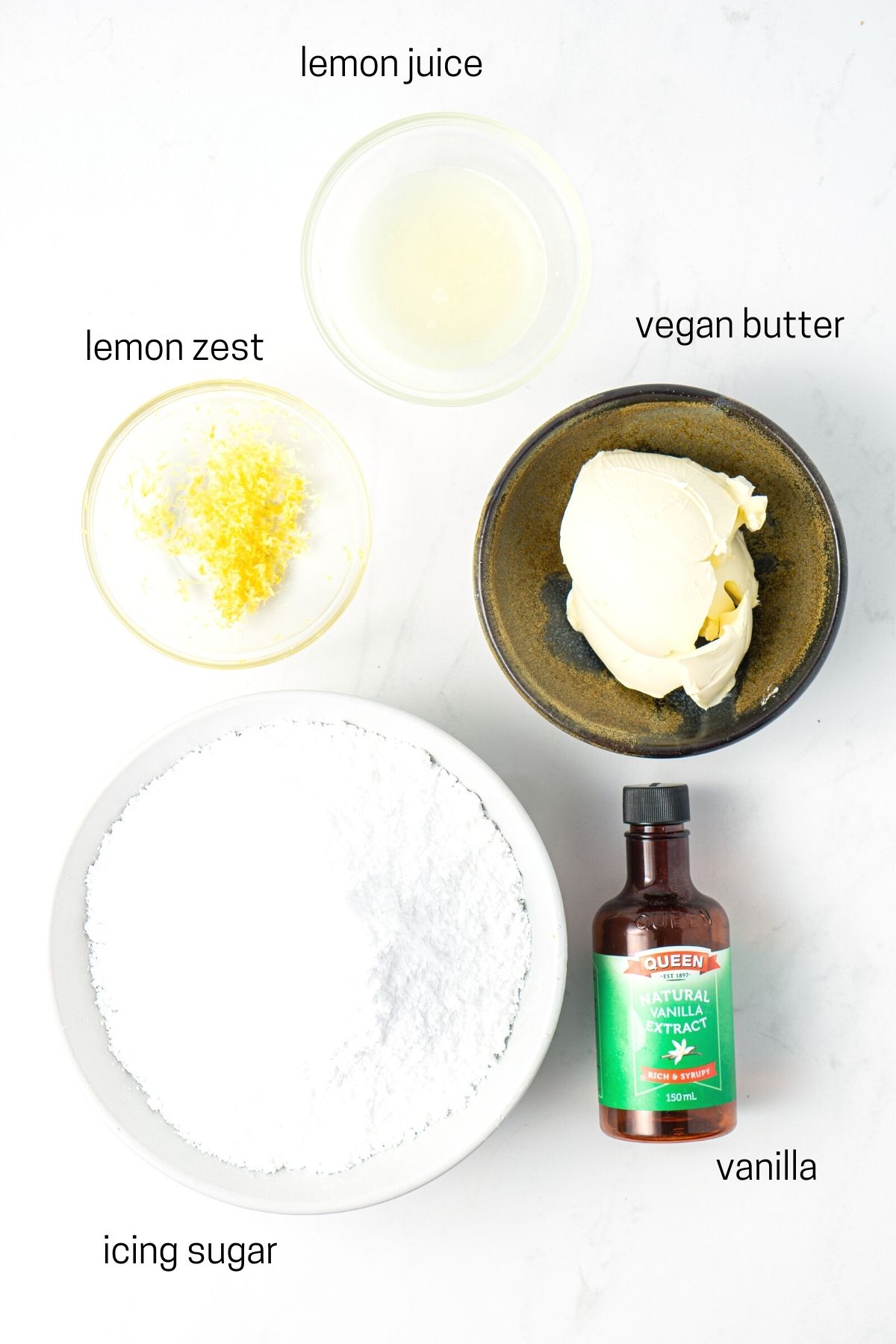 All ingredients needed for vegan lemon buttercream laid out in small bowls.